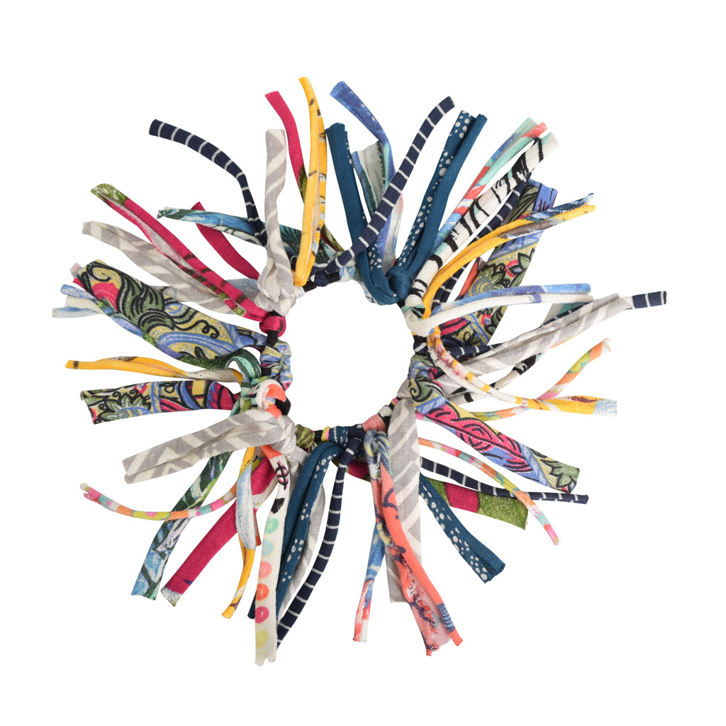 Eco DIY Scrunchie Kit featuring colorful upcycled materials and hair ties for crafting stylish scrunchies.