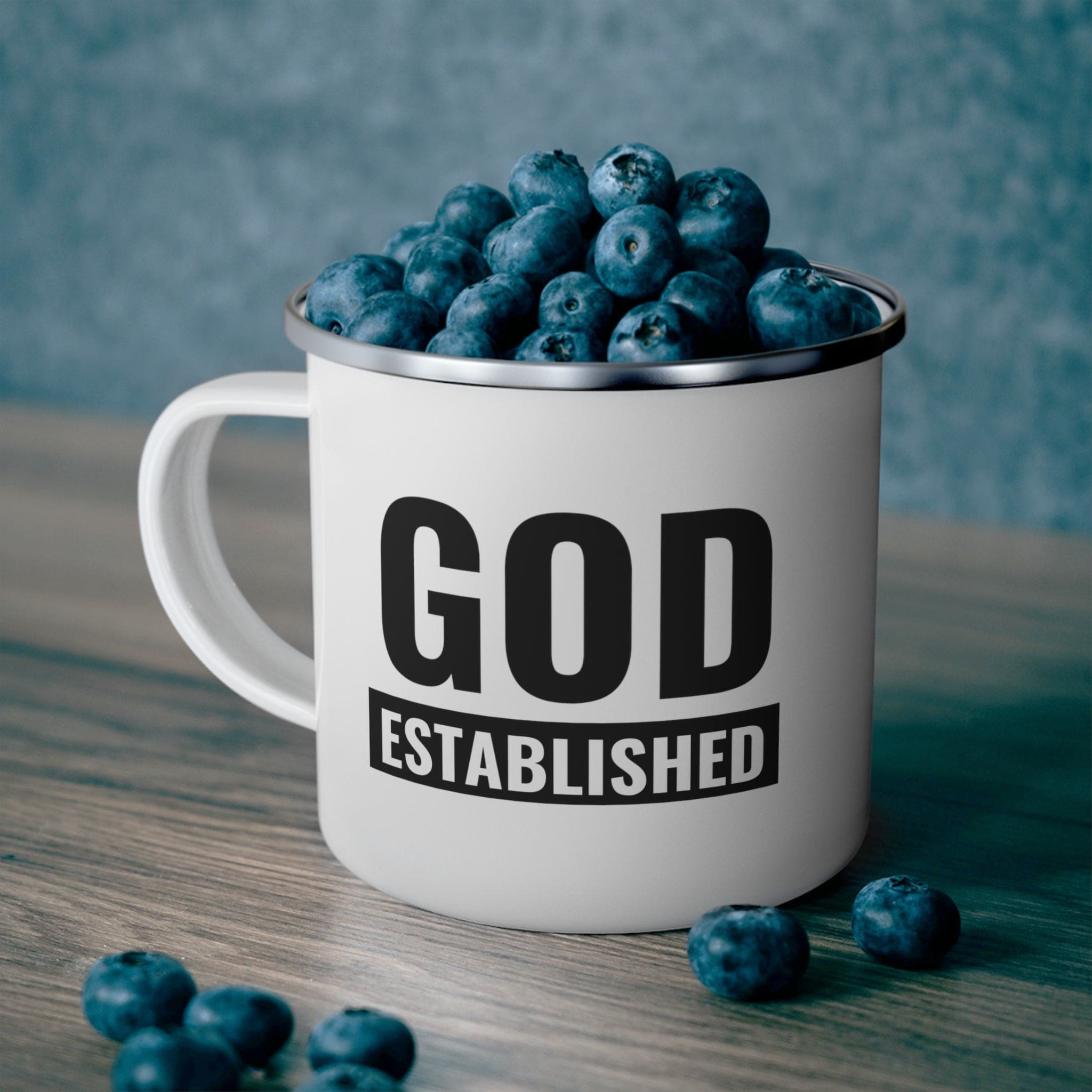 Durable enamel camping mug with God Established black illustration, perfect for outdoor activities.