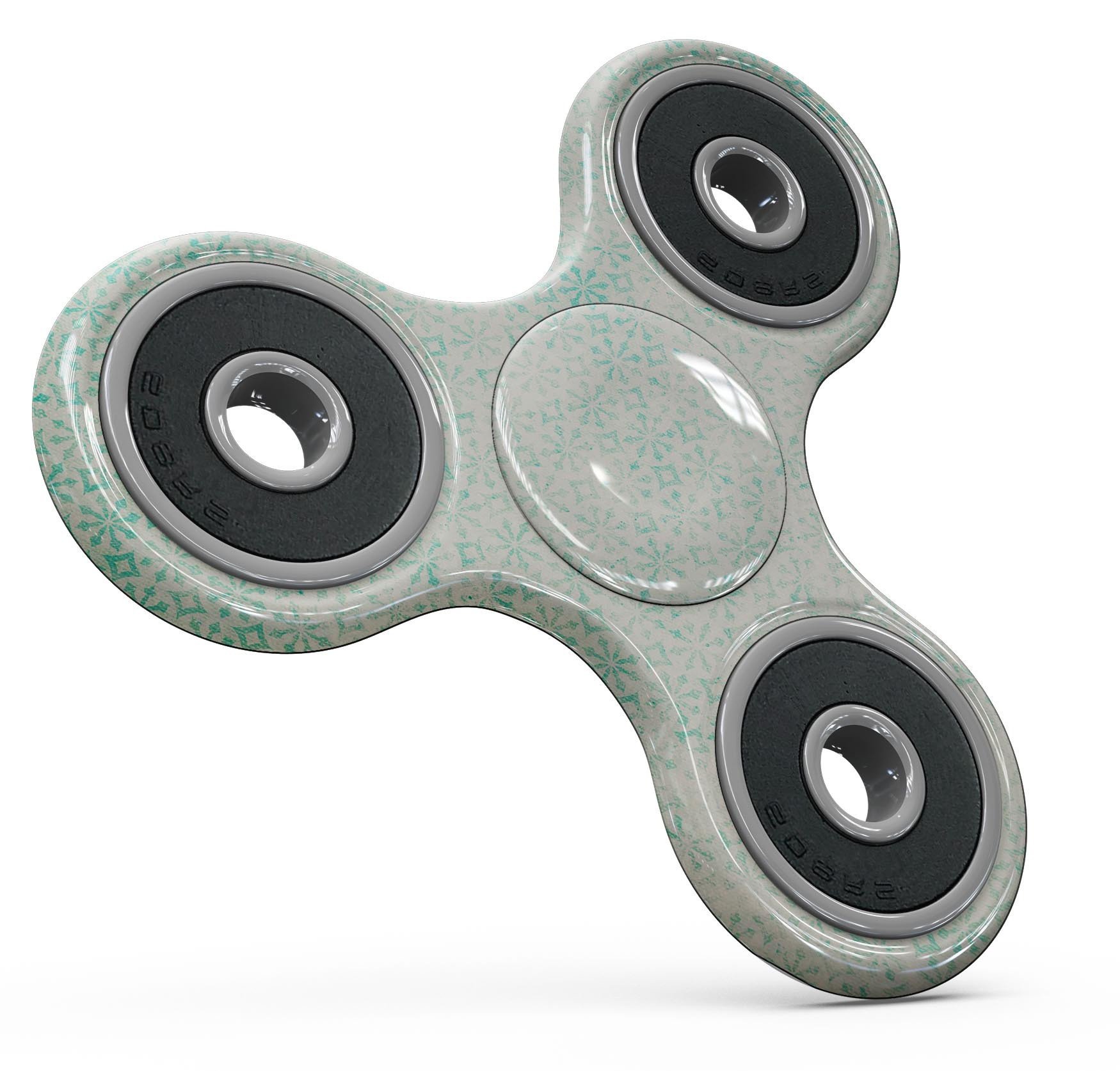 Faded teal fidget spinner skin kit featuring a snowflake pattern, showcasing vibrant colors and a sleek design.