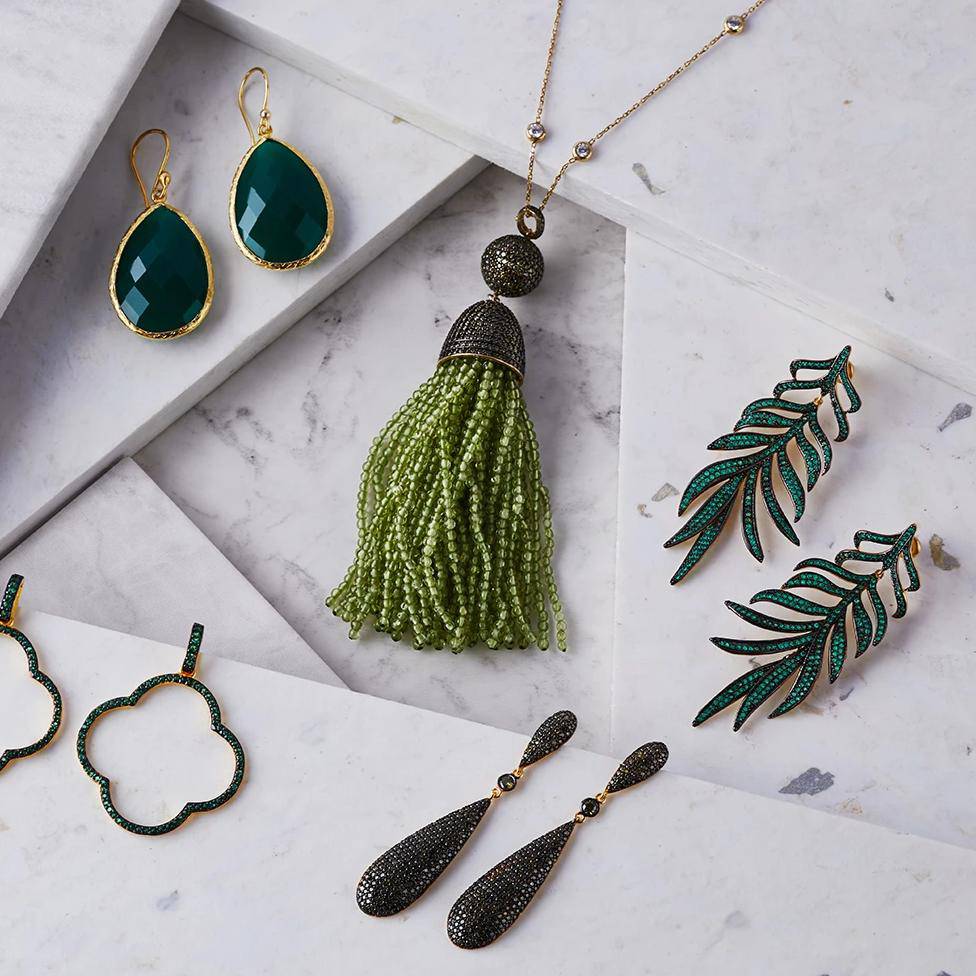 Elegant Feathered Leaf Statement Drop Earrings featuring green cubic zirconia, crafted from sterling silver and dipped in gold.