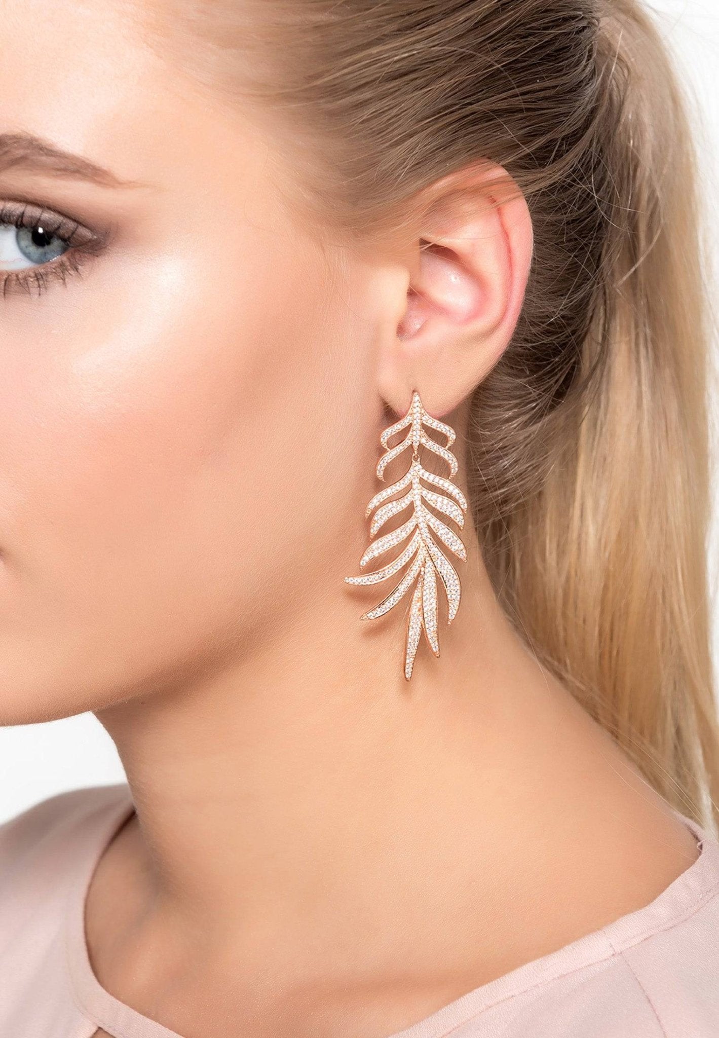 Elegant Feathered Leaf Statement Drop Earrings in rosegold, featuring sparkling cubic zirconia and a nature-inspired design.