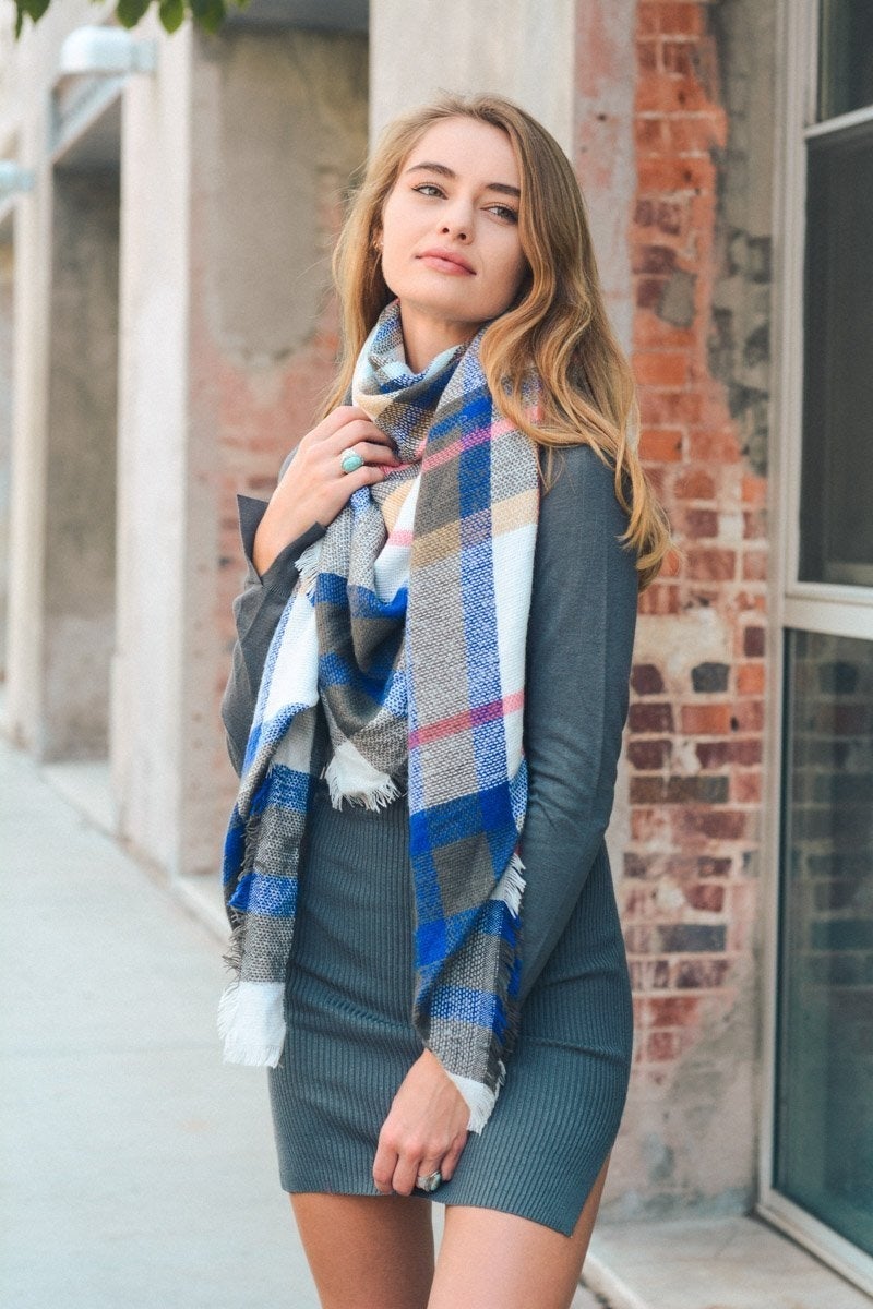 A cozy Flannel Frayed Edge Blanket Scarf in a stylish design, showcasing its soft texture and frayed edges.