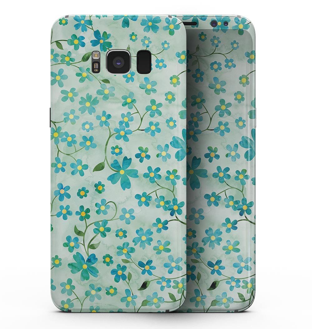 Samsung Galaxy S8 with a floral skin featuring flowers and stems over a light green watercolor background.
