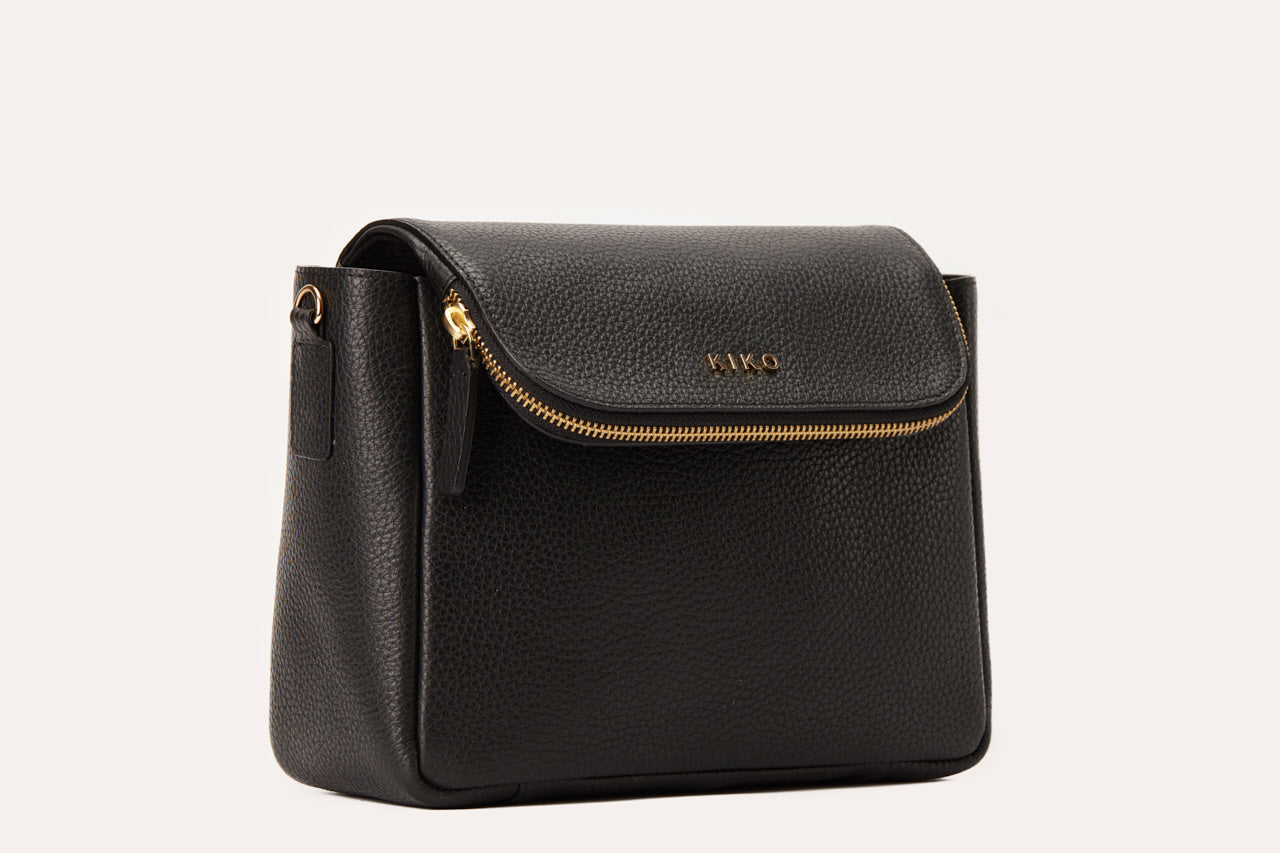 Fold Over Crossbody bag made of genuine pebble leather with a magnetic closure and adjustable strap.