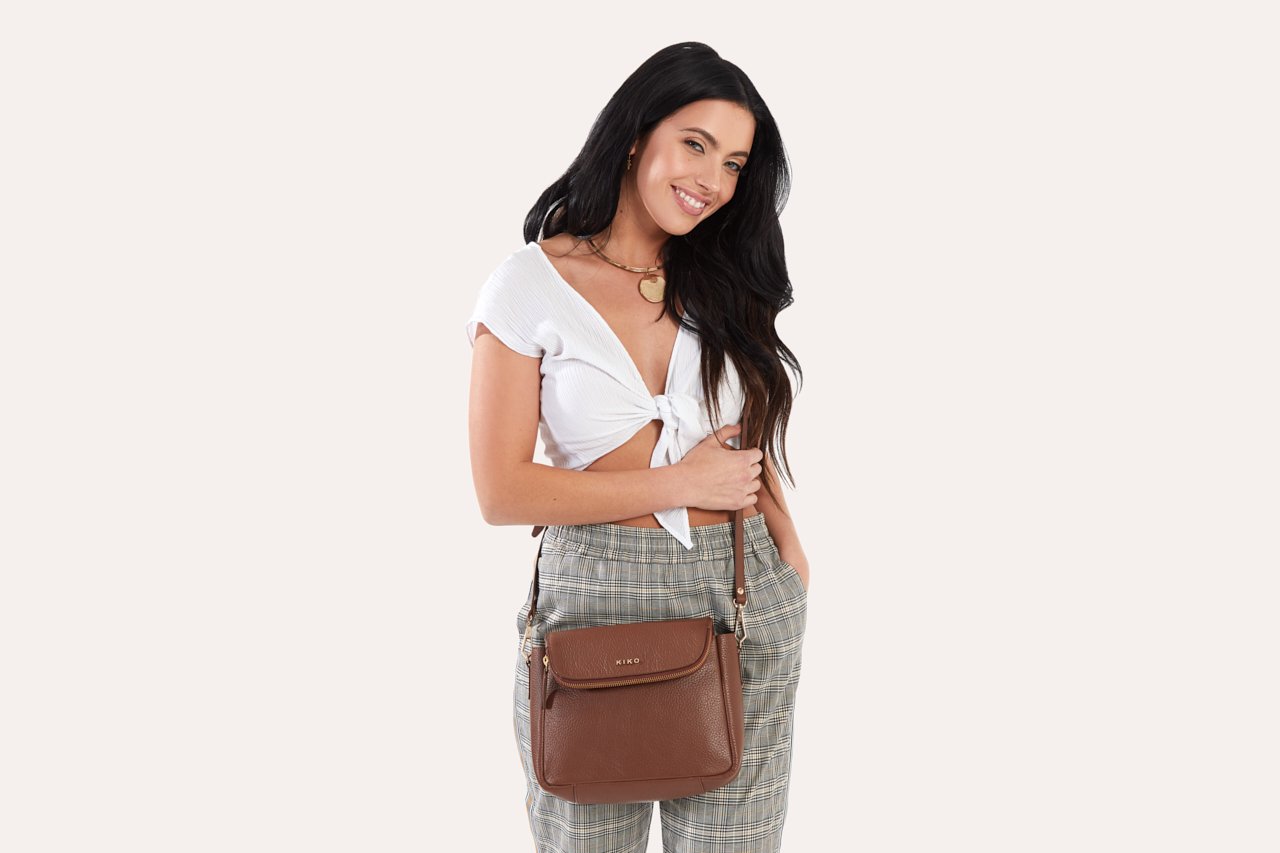 Fold Over Crossbody bag made of genuine pebble leather with a magnetic closure and adjustable strap.