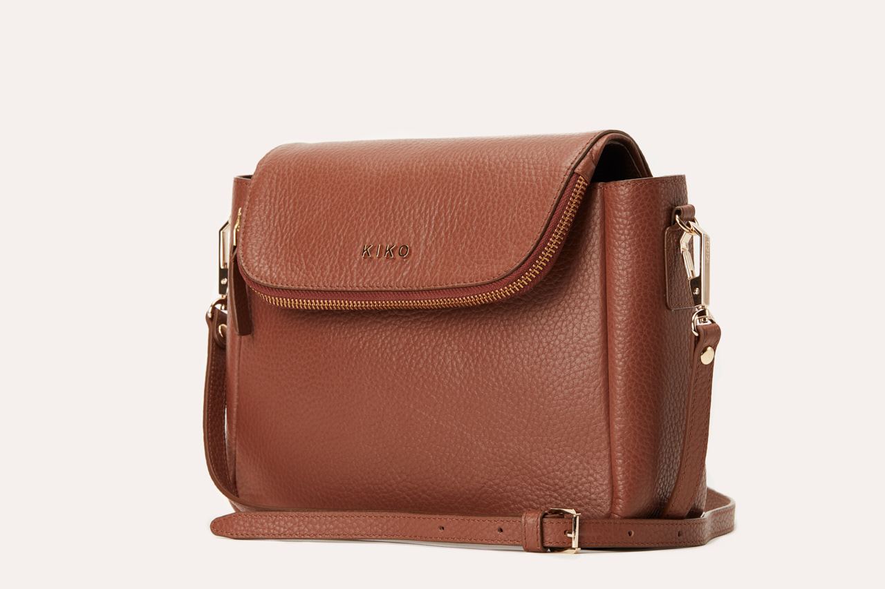 Fold Over Crossbody bag made of genuine pebble leather with a magnetic closure and adjustable strap.