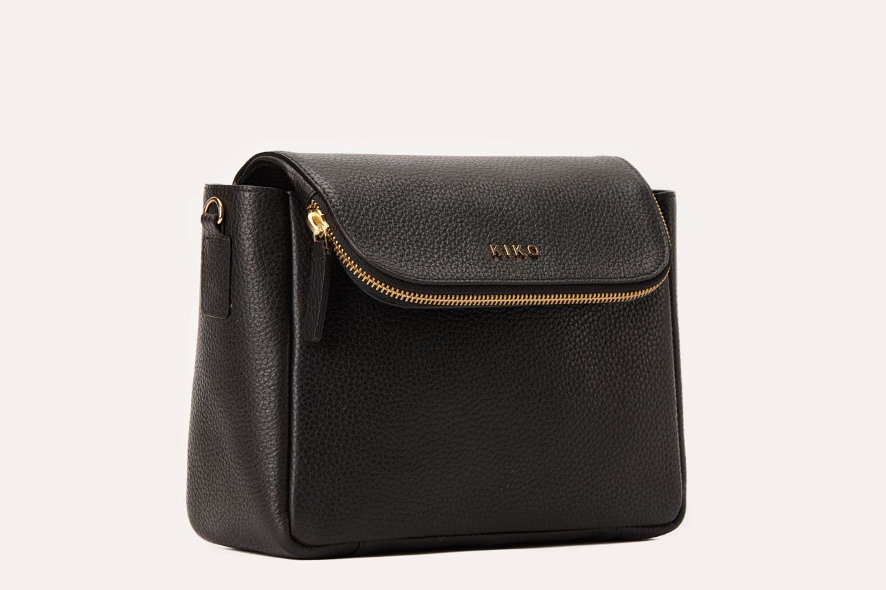 Fold Over Crossbody bag made of genuine pebble leather with a magnetic closure and adjustable strap.