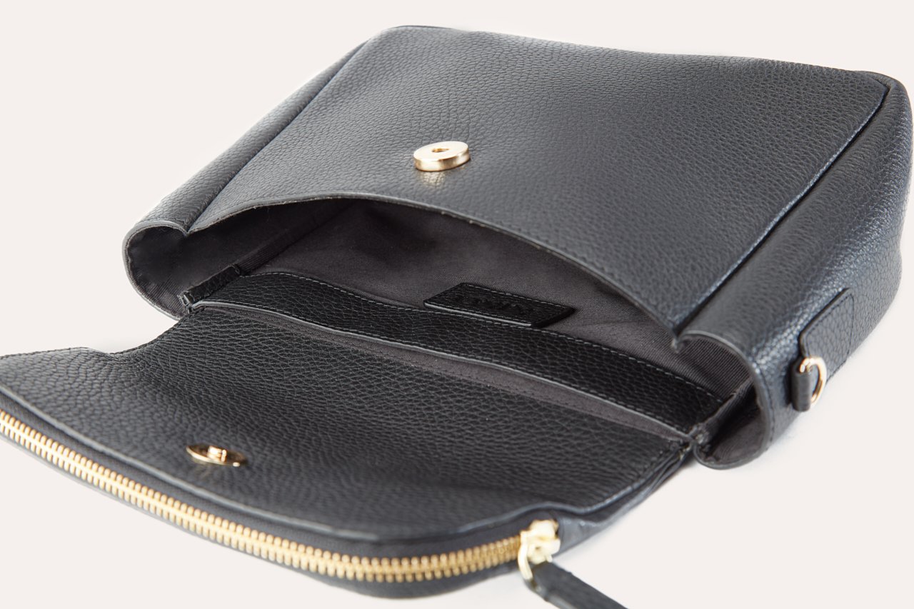 Fold Over Crossbody bag made of genuine pebble leather with a magnetic closure and adjustable strap.