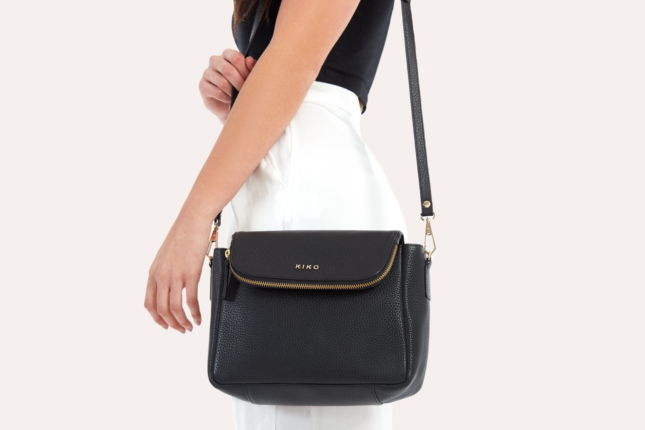 Fold Over Crossbody bag made of genuine pebble leather with a magnetic closure and adjustable strap.