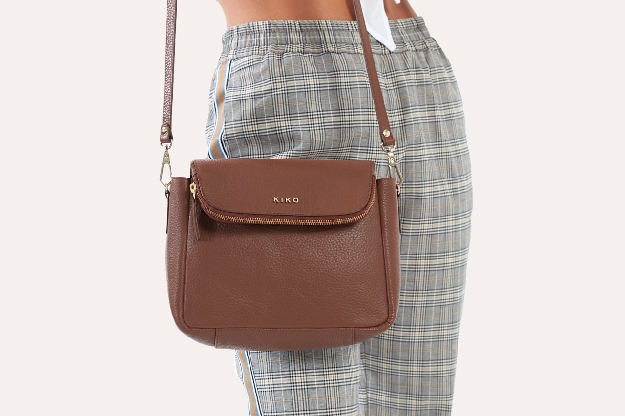 Fold Over Crossbody bag made of genuine pebble leather with a magnetic closure and adjustable strap.