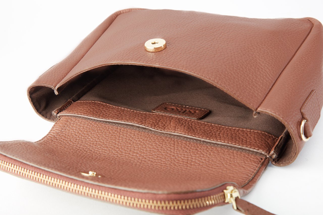 Fold Over Crossbody bag made of genuine pebble leather with a magnetic closure and adjustable strap.