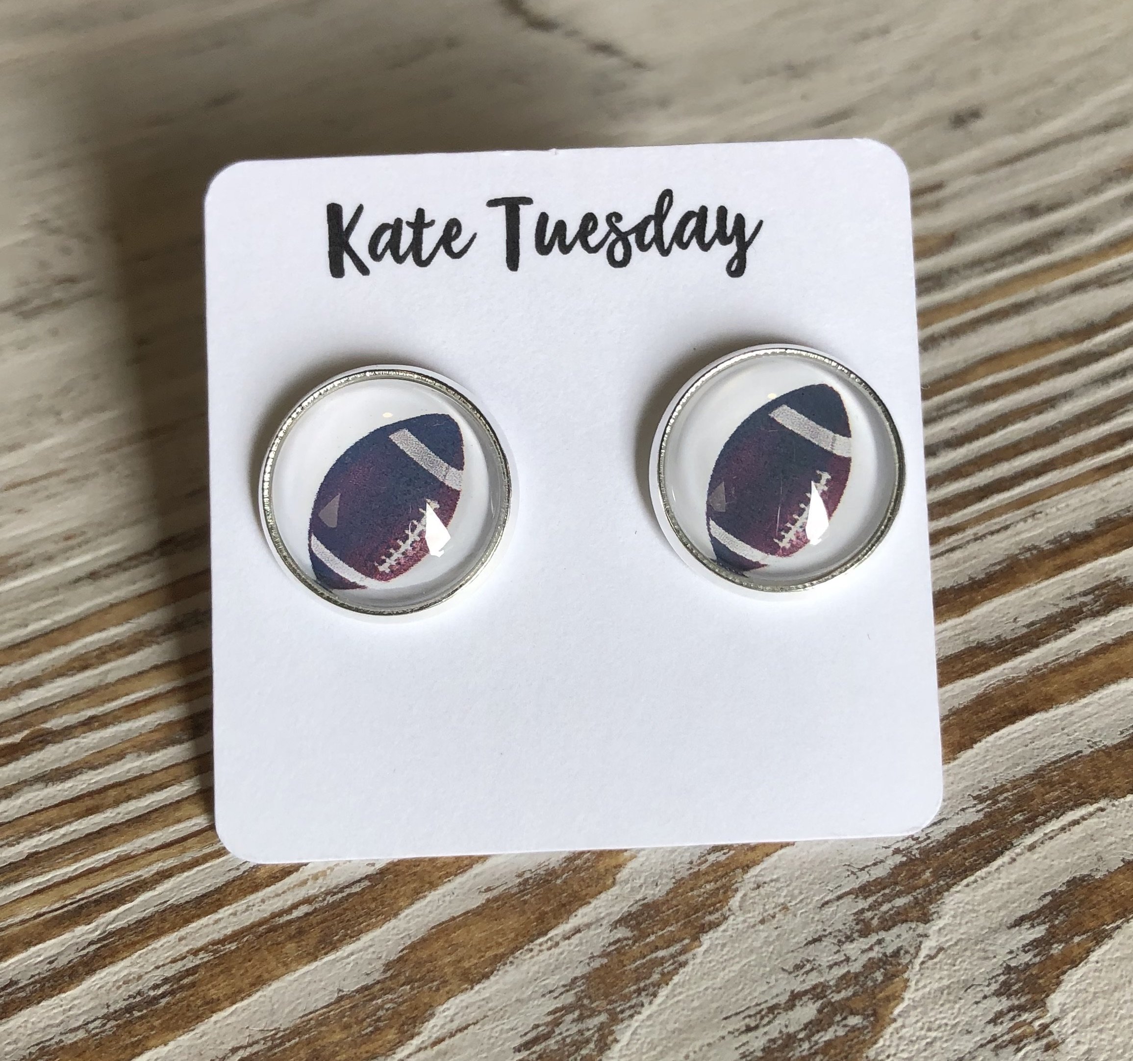A pair of 12mm football-themed stud earrings, lead and nickel free, showcasing a stylish design for sports enthusiasts.