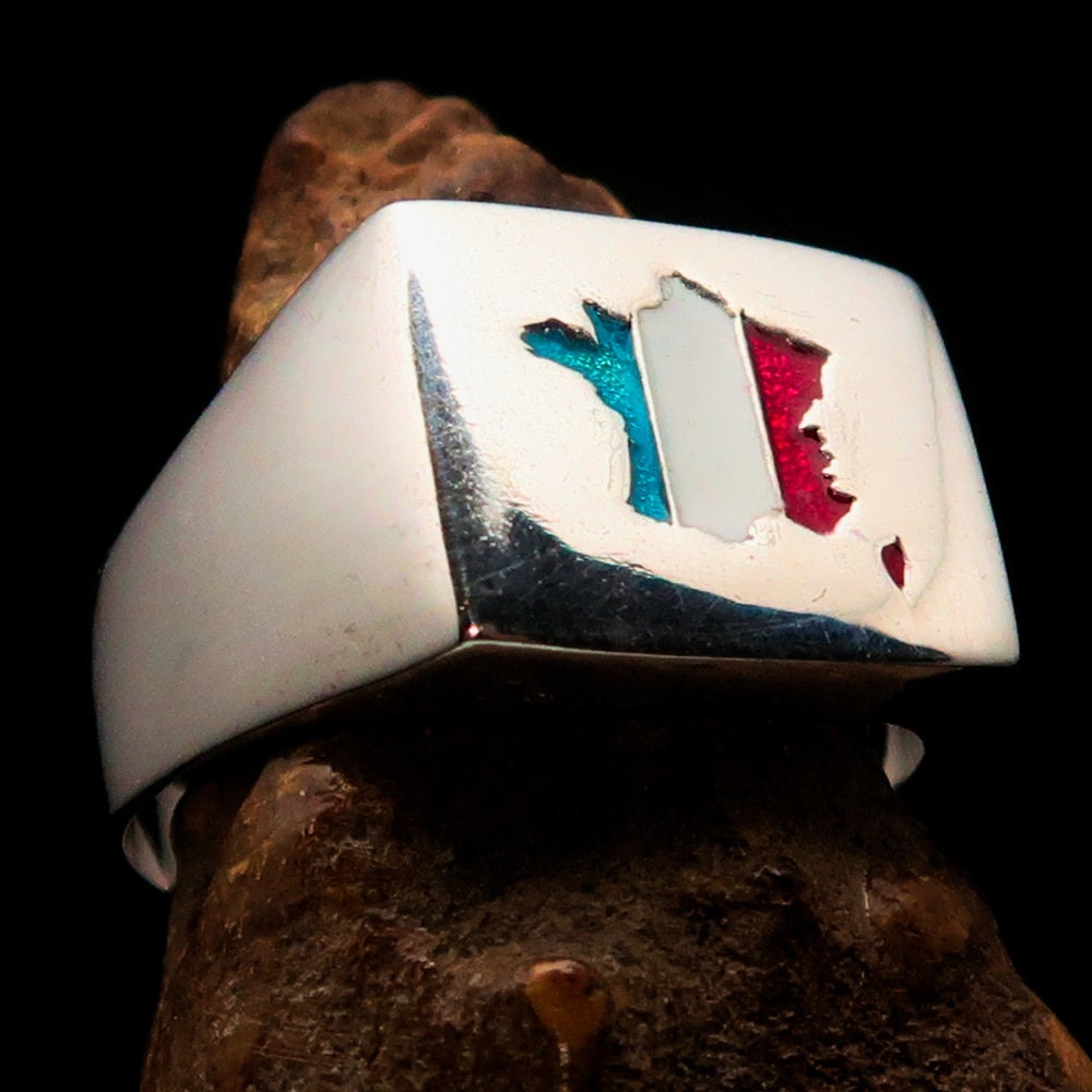 A polished sterling silver pinky ring featuring the flag of France, showcasing vibrant colors and the RCRN logo engraved.