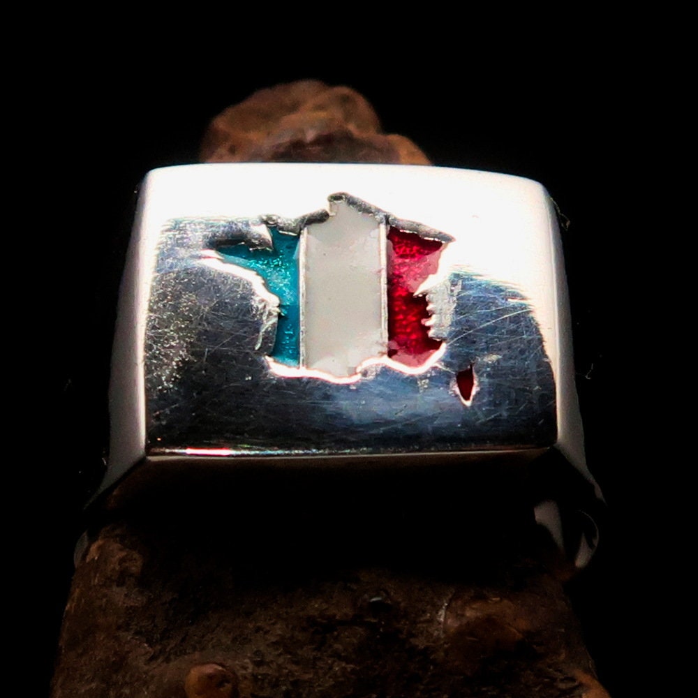 A polished sterling silver pinky ring featuring the flag of France, showcasing vibrant colors and the RCRN logo engraved.