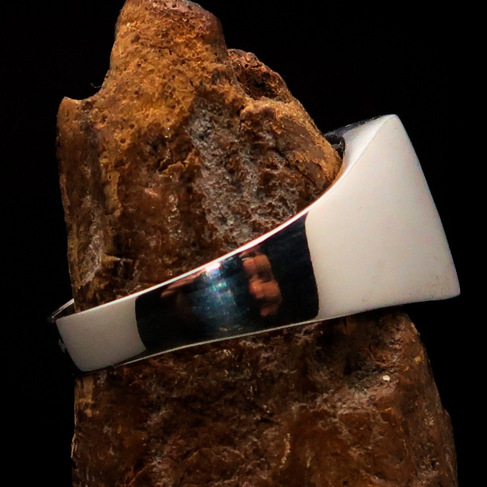 A polished sterling silver pinky ring featuring the flag of France, showcasing vibrant colors and the RCRN logo engraved.