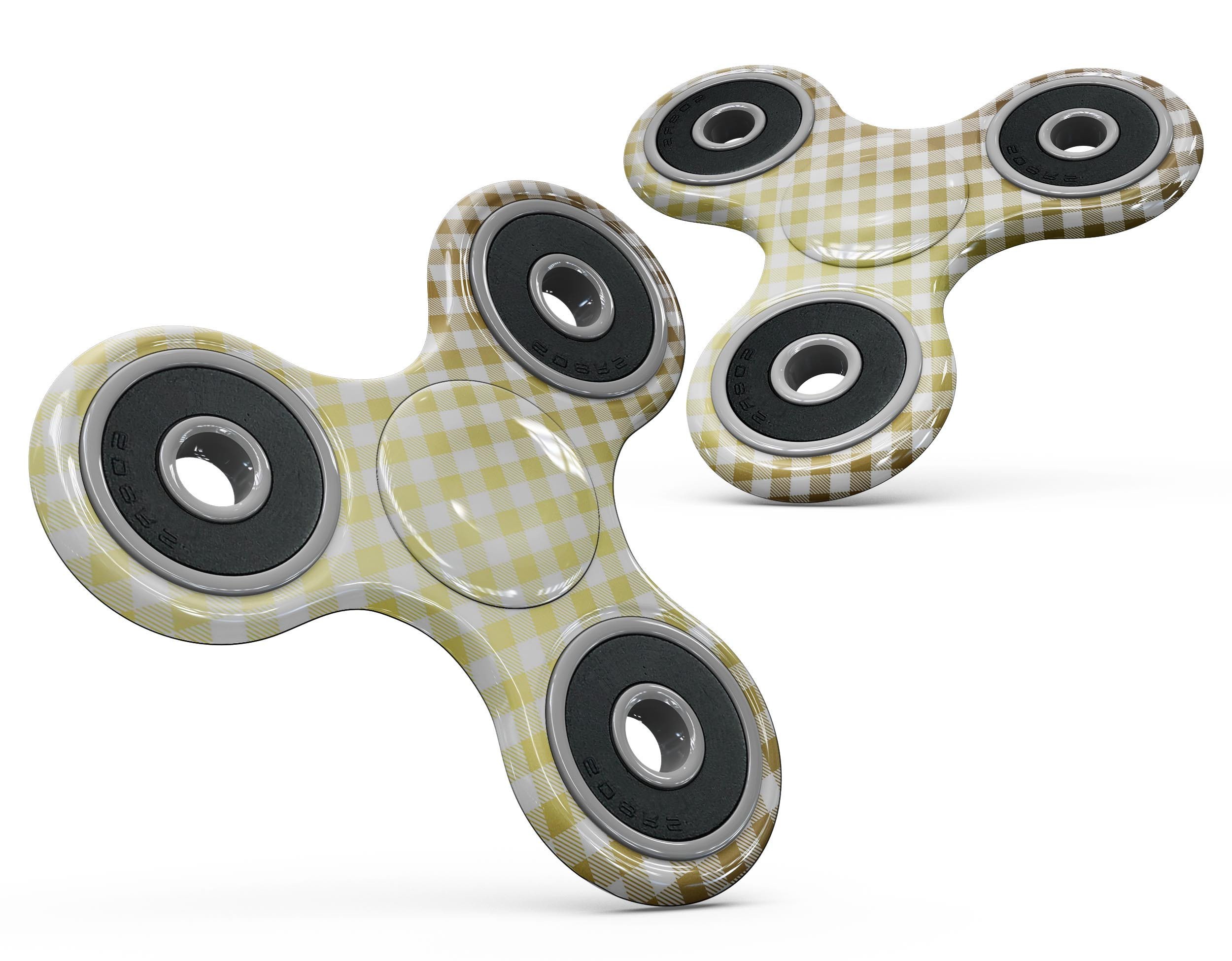 Gold and white plaid patterned skin for fidget spinner, showcasing a stylish design that protects the device.