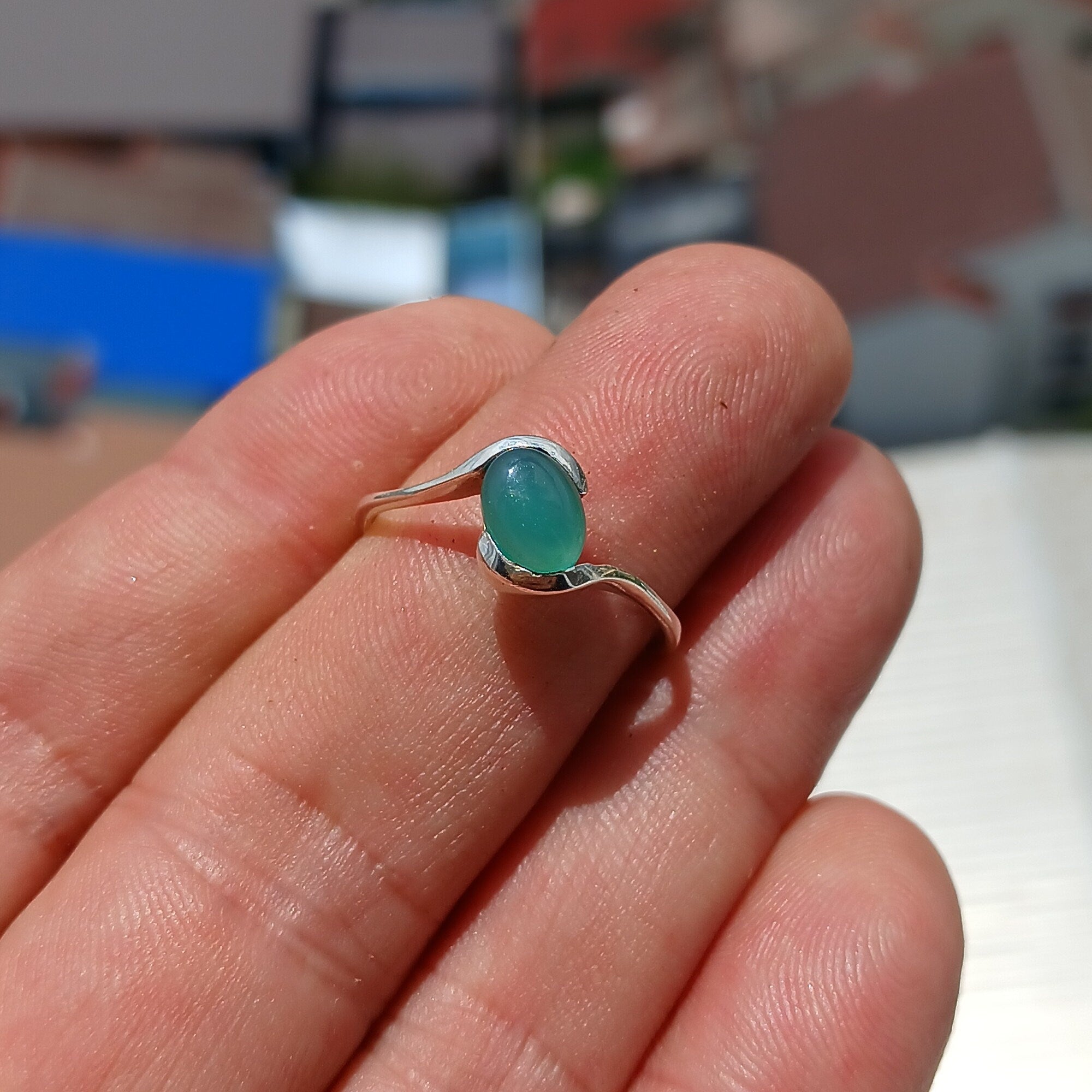 Minimalist Green Agate Ring with sterling silver band and oval cabochon, showcasing elegant design and craftsmanship.