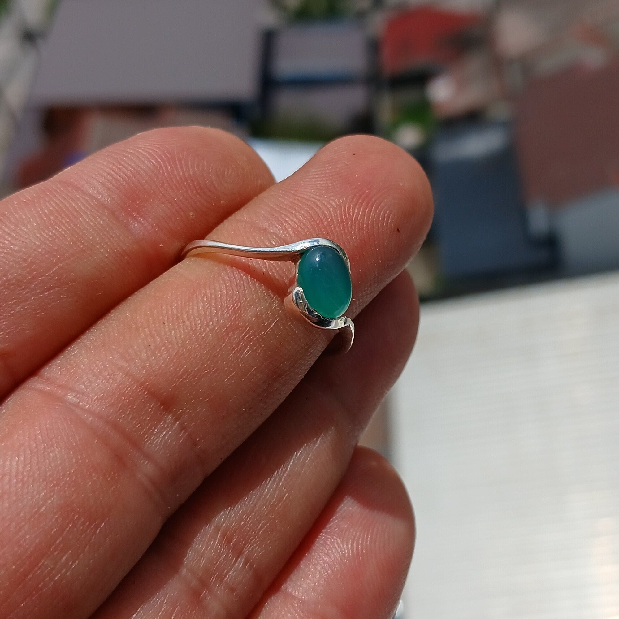 Minimalist Green Agate Ring with sterling silver band and oval cabochon, showcasing elegant design and craftsmanship.