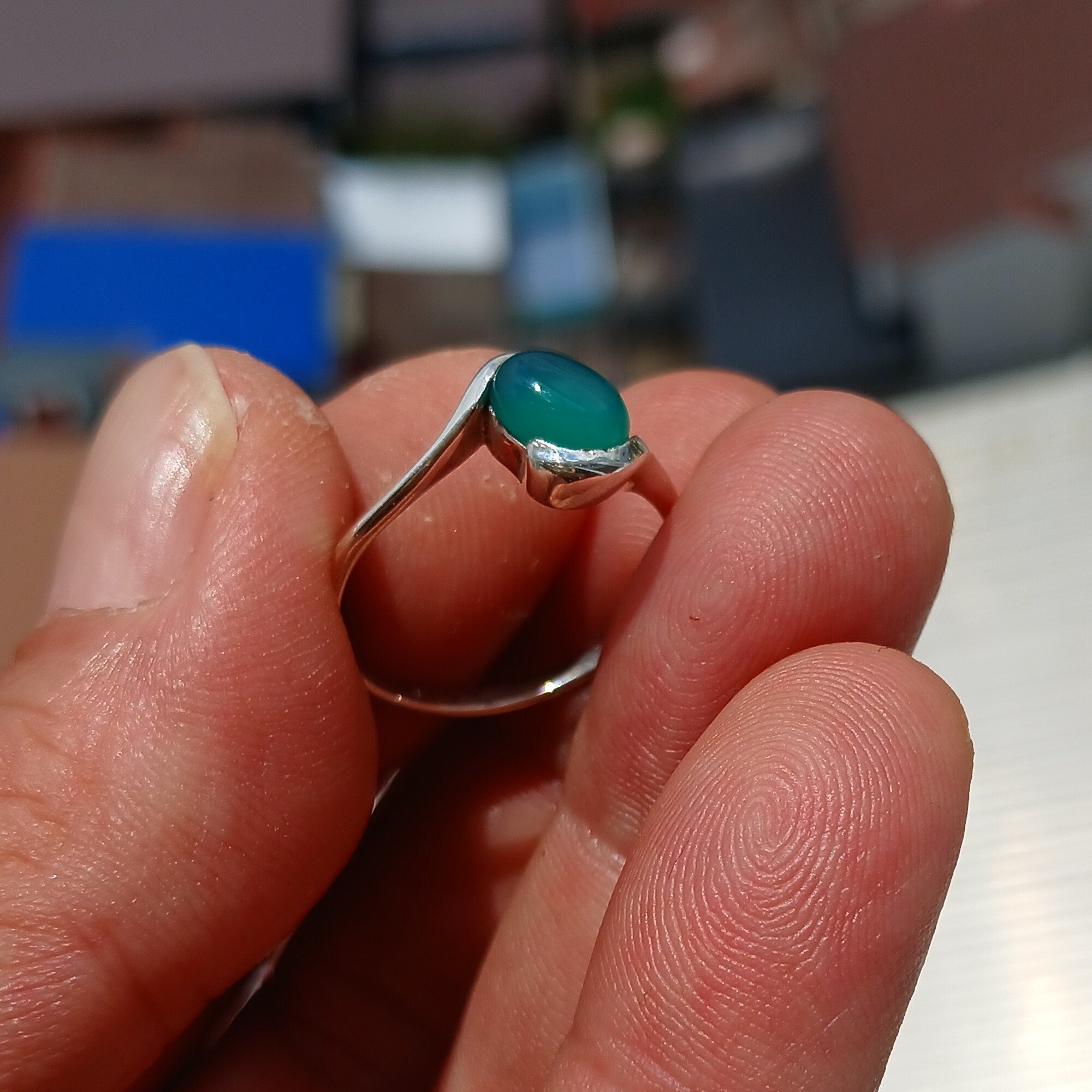 Minimalist Green Agate Ring with sterling silver band and oval cabochon, showcasing elegant design and craftsmanship.