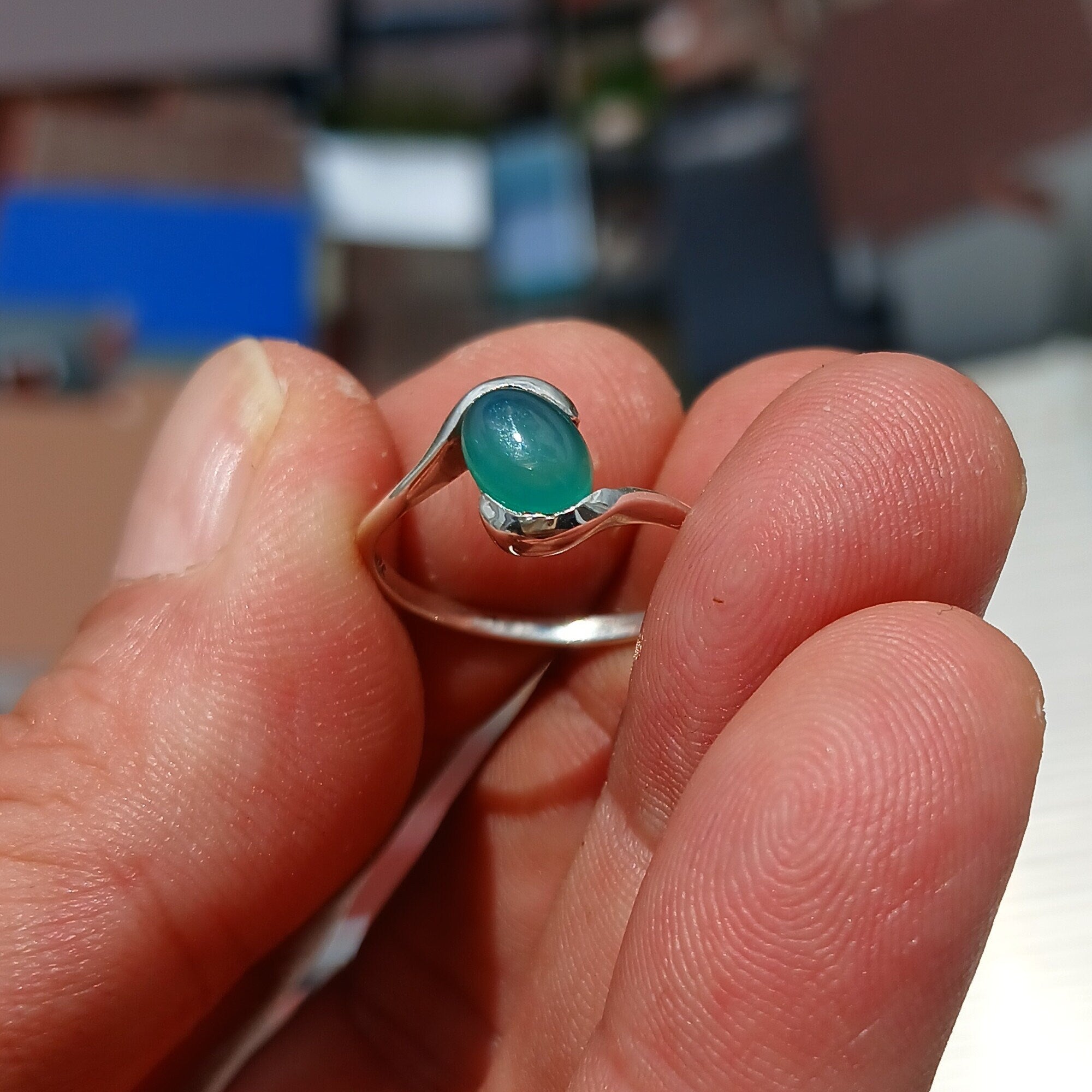 Minimalist Green Agate Ring with sterling silver band and oval cabochon, showcasing elegant design and craftsmanship.