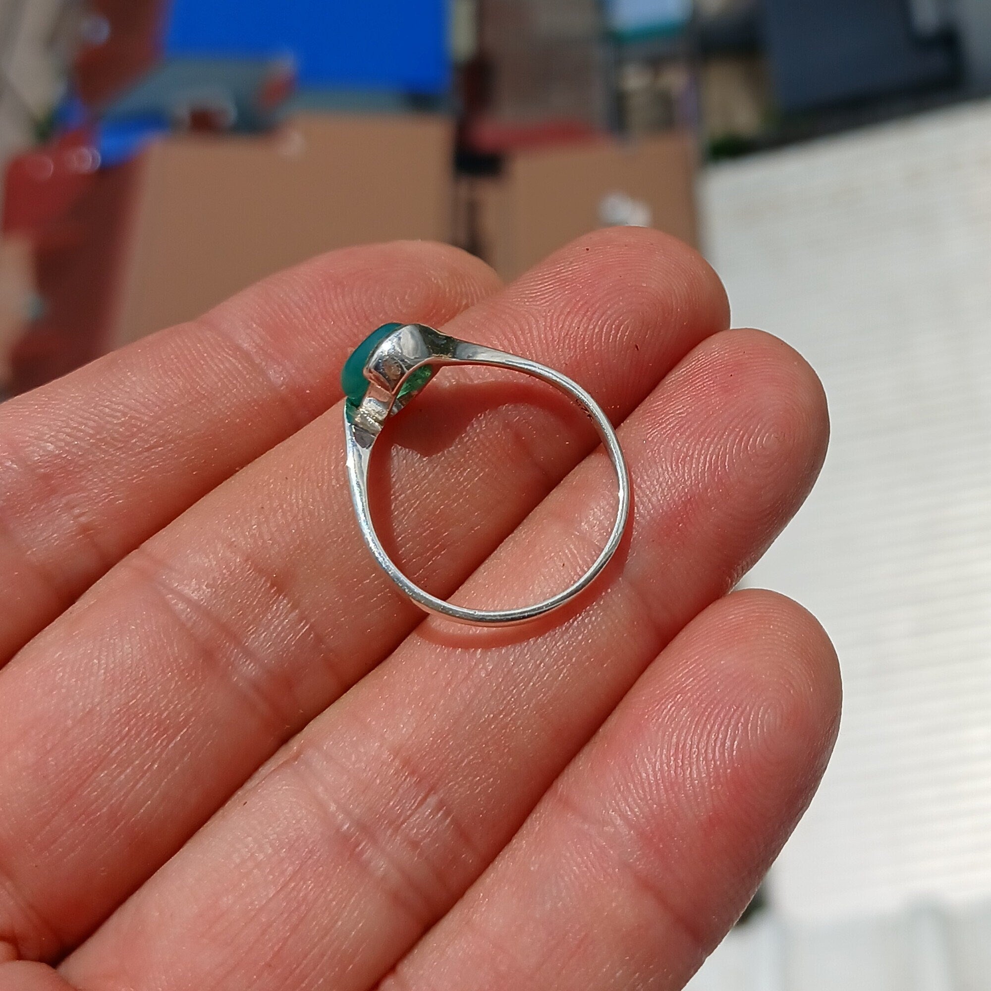 Minimalist Green Agate Ring with sterling silver band and oval cabochon, showcasing elegant design and craftsmanship.