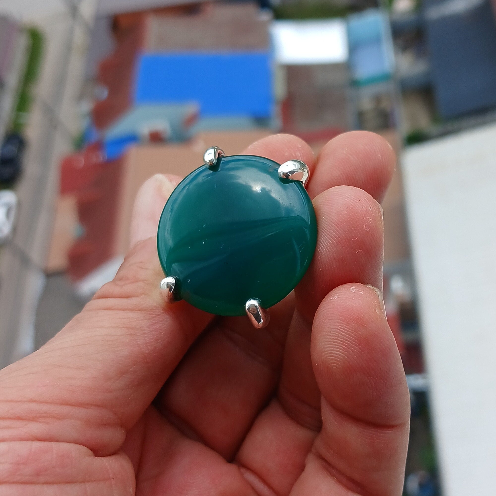 Minimalist Green Agate Ring with sterling silver band and round cabochon, showcasing its elegant design and polished finish.