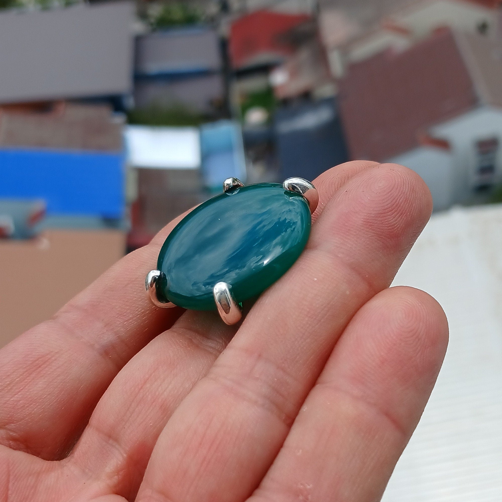 Minimalist Green Agate Ring with sterling silver band and round cabochon, showcasing its elegant design and polished finish.