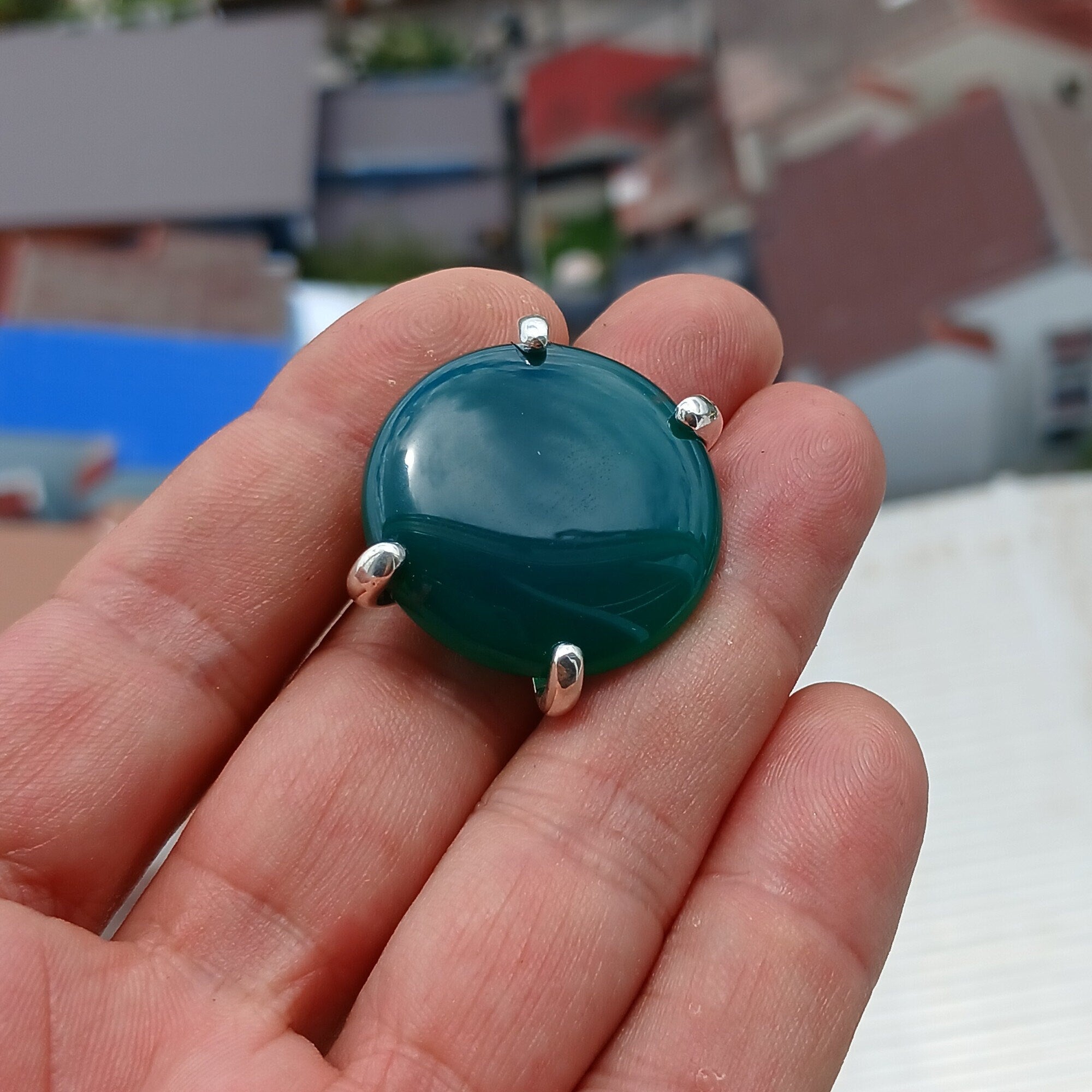 Minimalist Green Agate Ring with sterling silver band and round cabochon, showcasing its elegant design and polished finish.