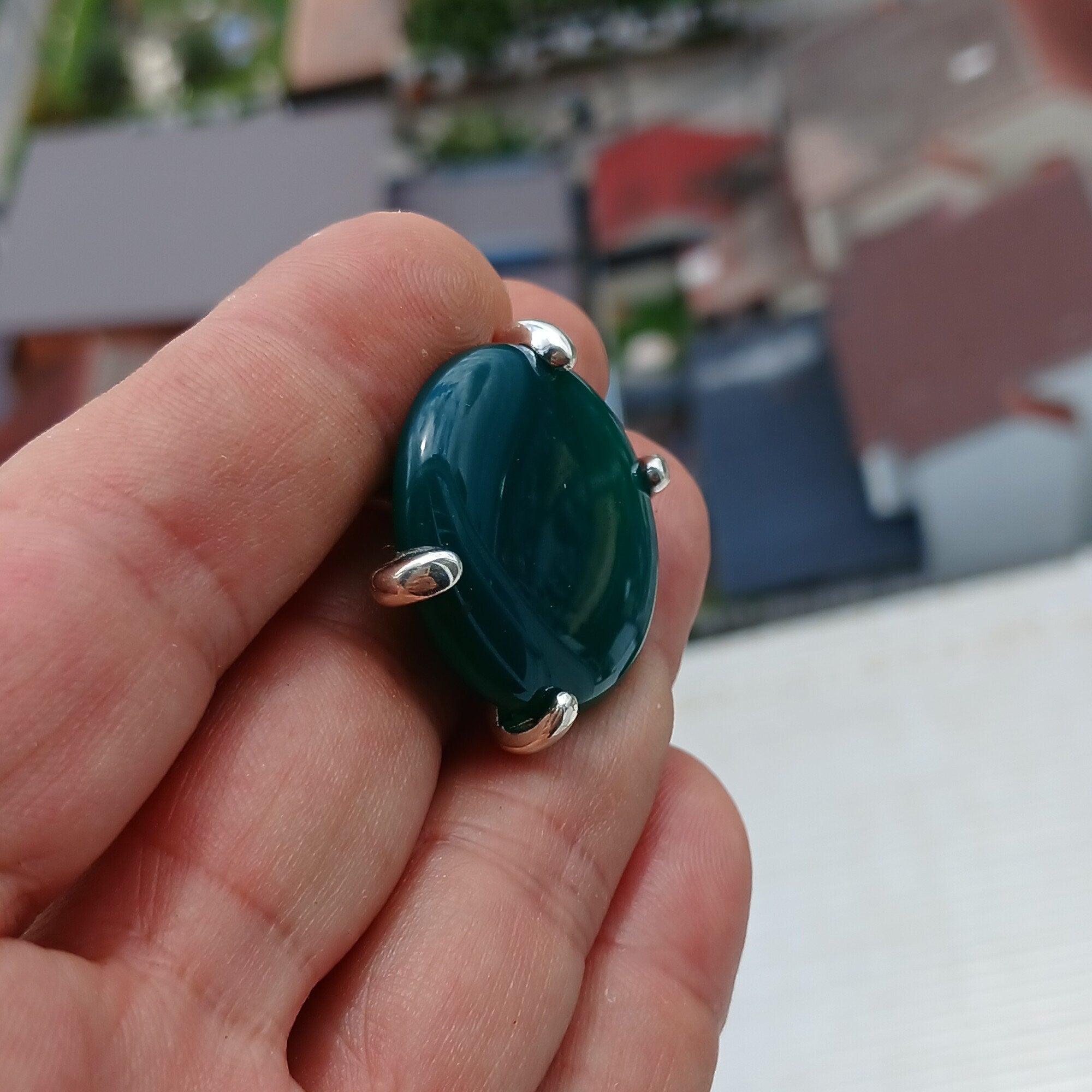 Minimalist Green Agate Ring with sterling silver band and round cabochon, showcasing its elegant design and polished finish.