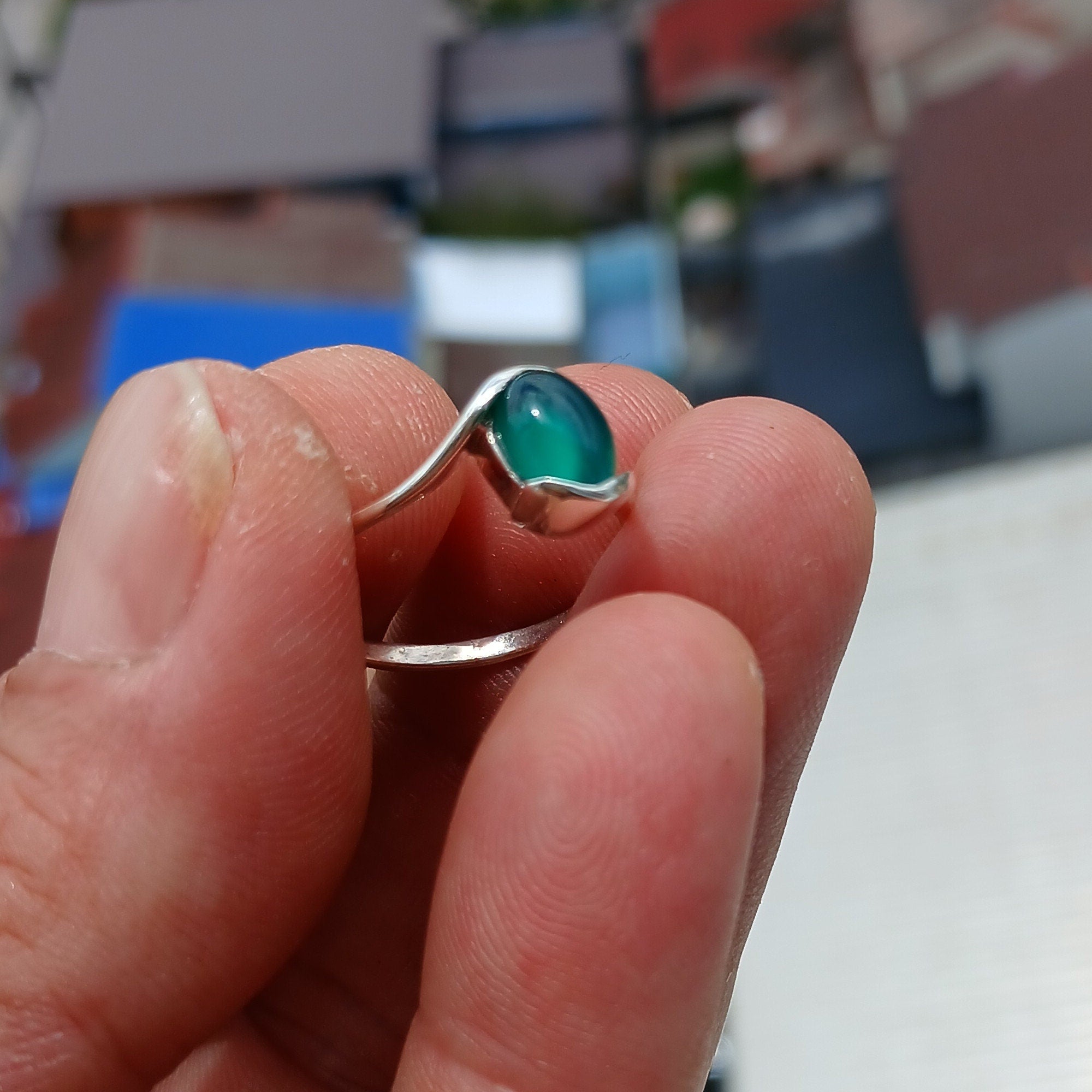 A minimalist Green Agate Ring featuring a handmade sterling silver band and an oval green Agate cabochon, elegantly polished.