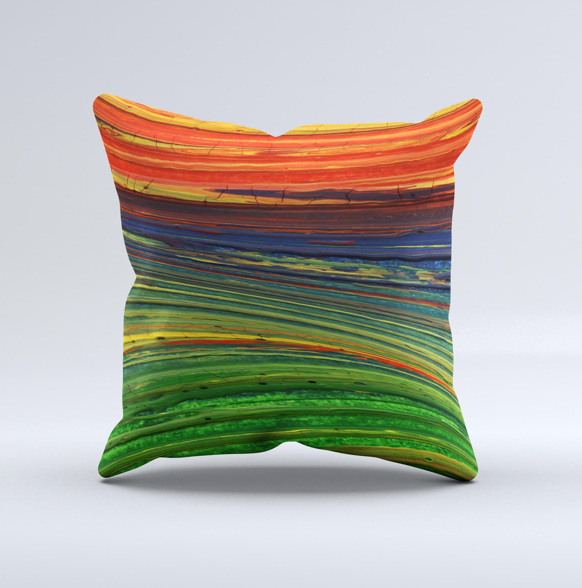 A vibrant decorative throw pillow featuring green, blue, and red painted oil waves, handcrafted in Virginia with a unique ink-fuzed design.