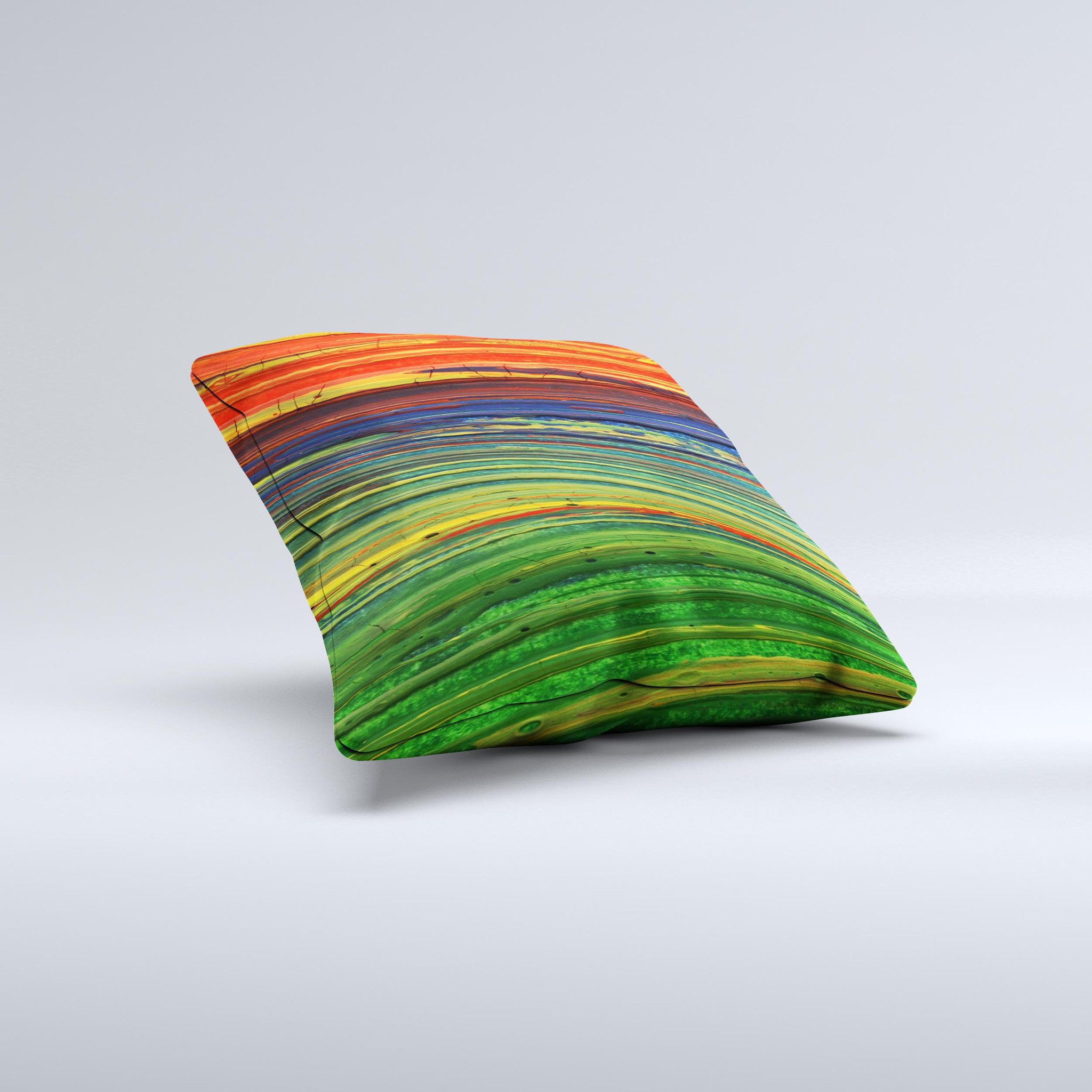 A vibrant decorative throw pillow featuring green, blue, and red painted oil waves, handcrafted in Virginia with a unique ink-fuzed design.