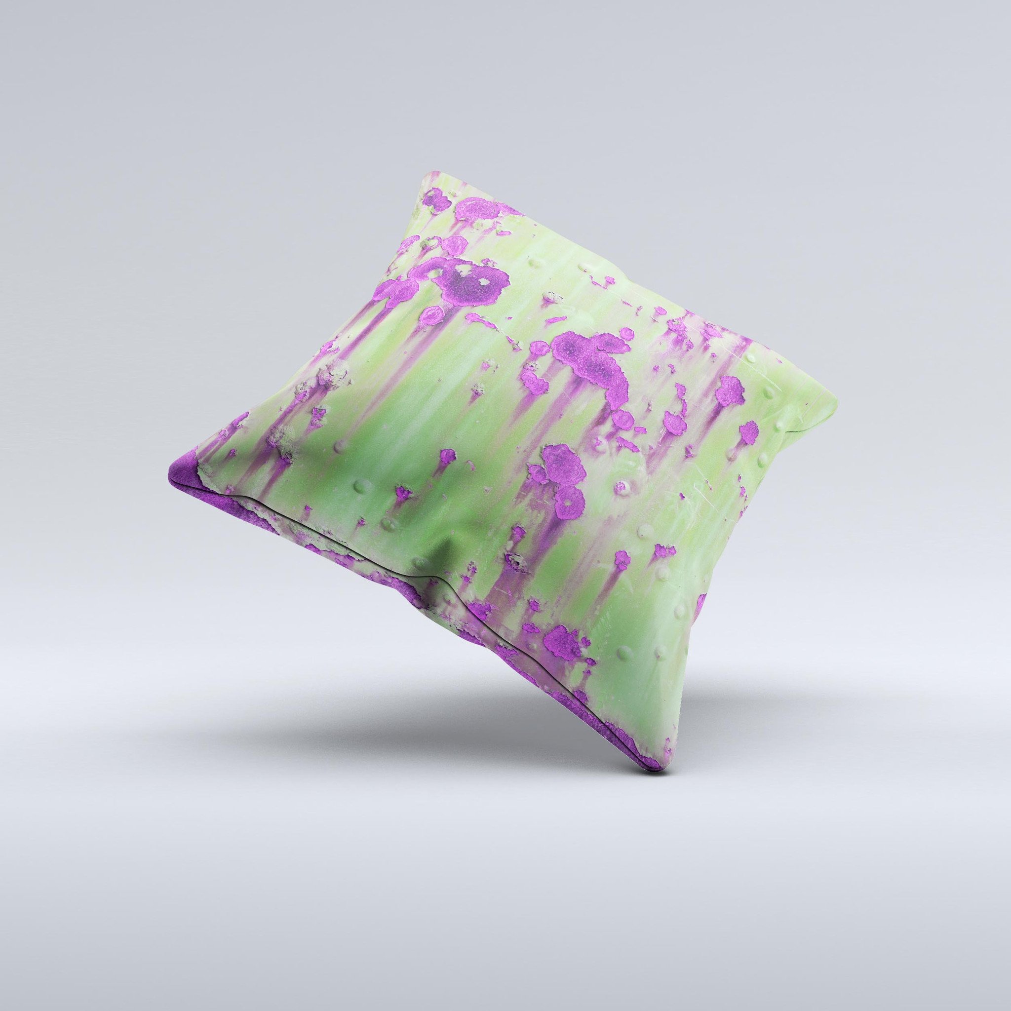 A decorative throw pillow featuring a green metal design with purple rust accents, handcrafted in Virginia, showcasing unique ink-fuzed graphics.