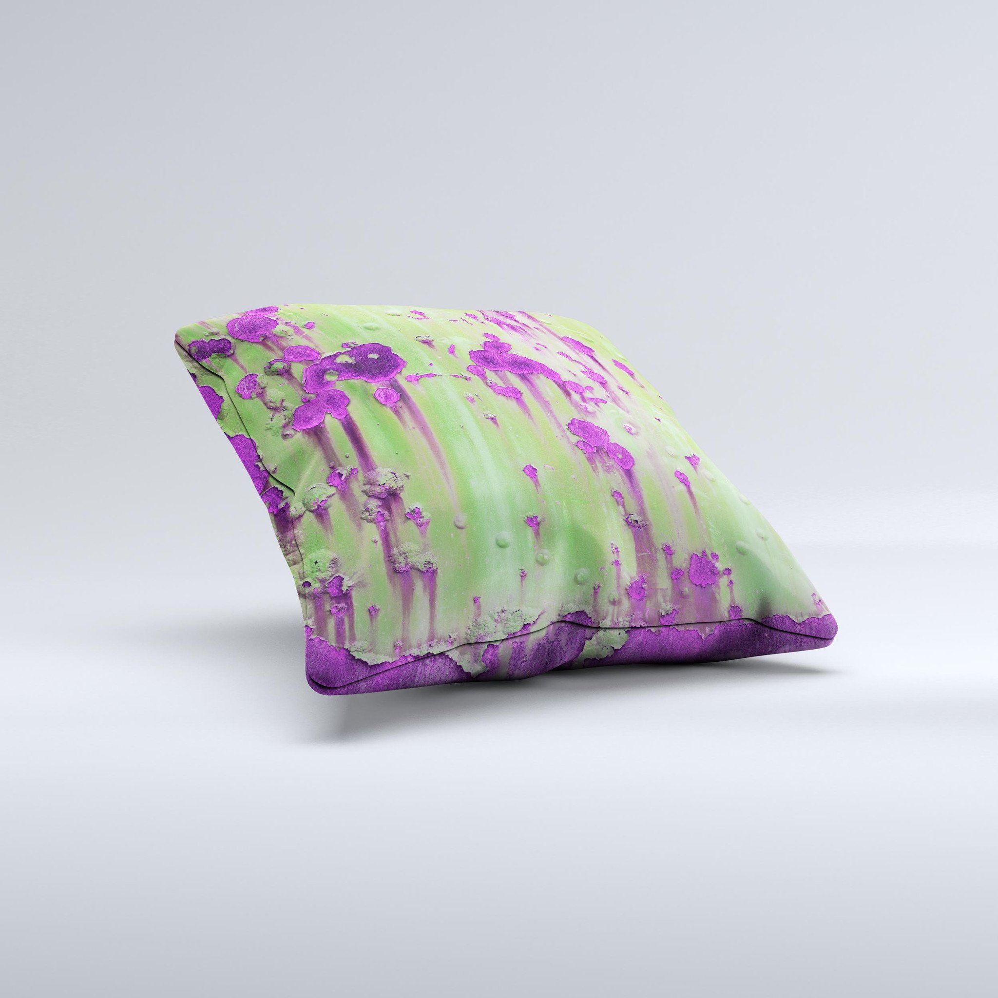 A decorative throw pillow featuring a green metal design with purple rust accents, handcrafted in Virginia, showcasing unique ink-fuzed graphics.