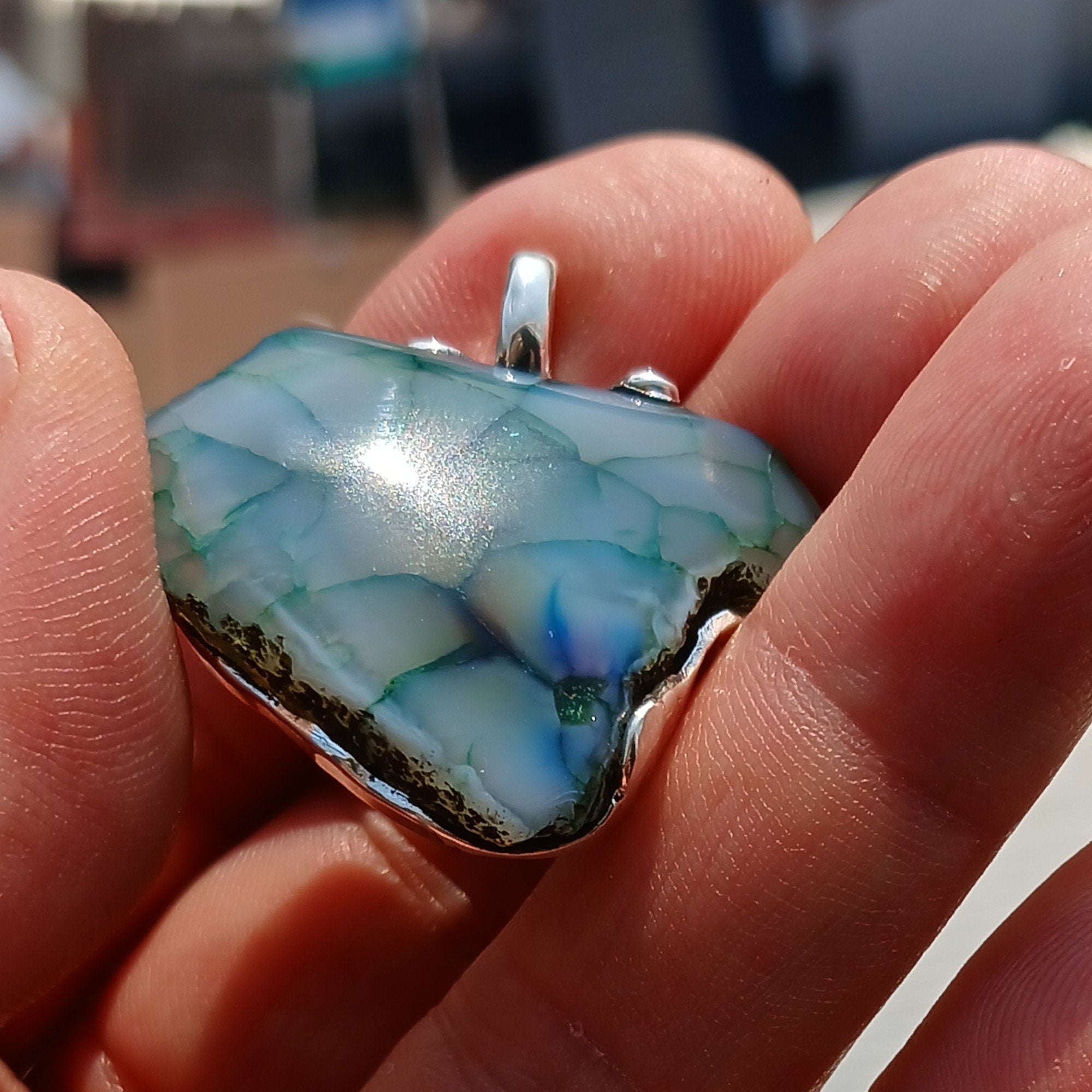 A beautiful Greenish Agate Amulet Sterling Silver Pendant featuring a vibrant green Agate stone set in intricate sterling silver artwork.