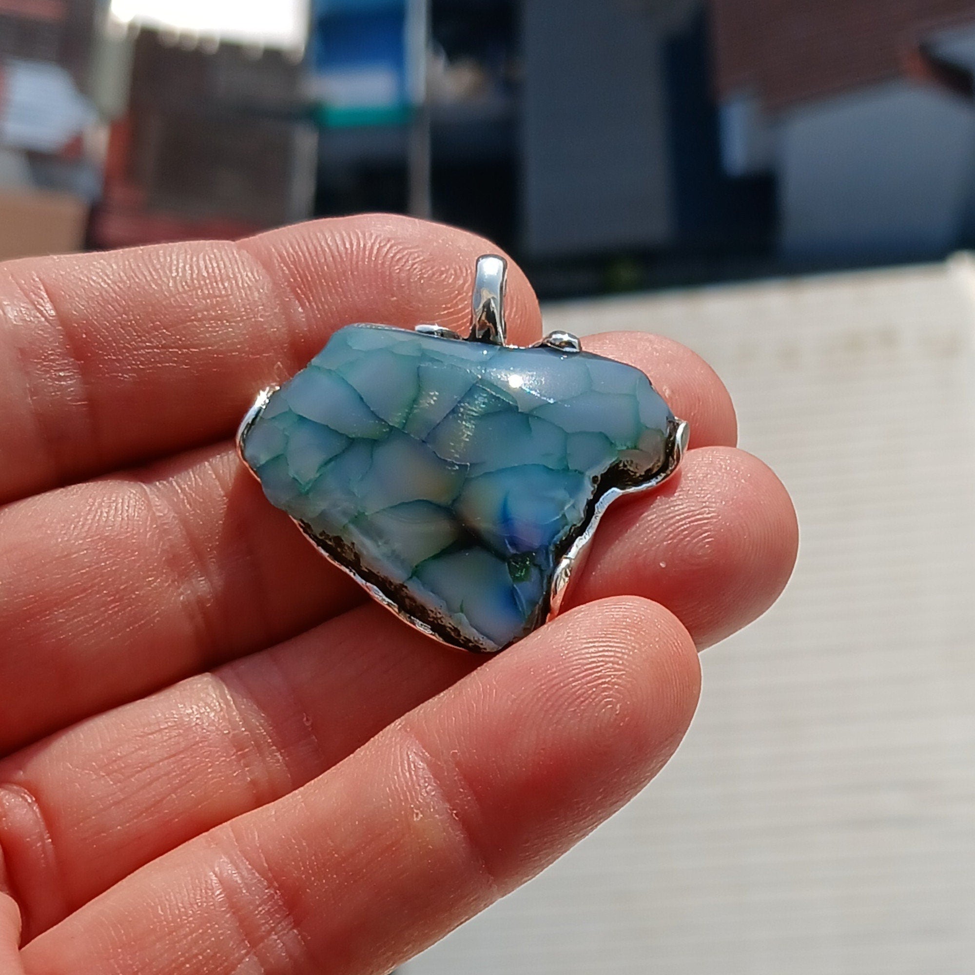 A beautiful Greenish Agate Amulet Sterling Silver Pendant featuring a vibrant green Agate stone set in intricate sterling silver artwork.