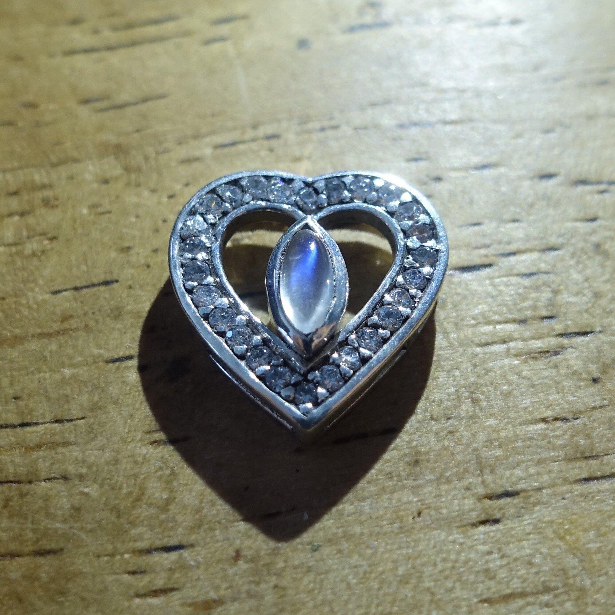 Sterling silver heart pendant featuring a Ceylon moonstone, elegantly designed with a polished finish.