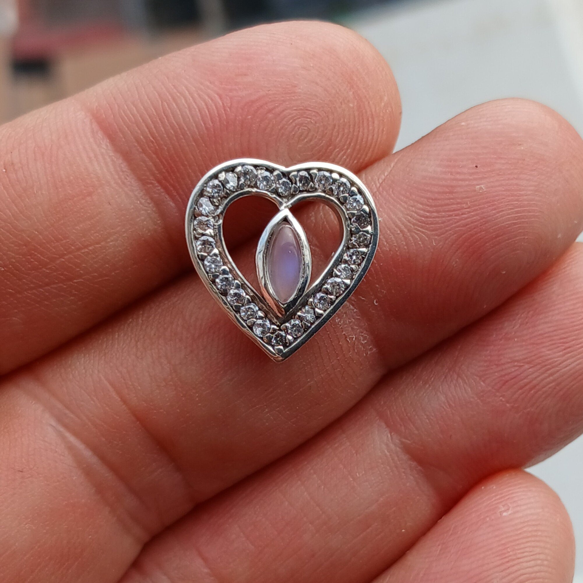 Sterling silver heart pendant featuring a Ceylon moonstone, elegantly designed with a polished finish.