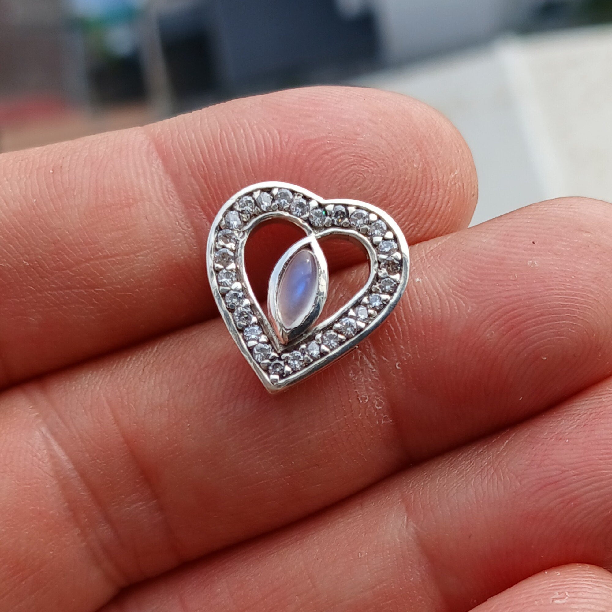 Sterling silver heart pendant featuring a Ceylon moonstone, elegantly designed with a polished finish.