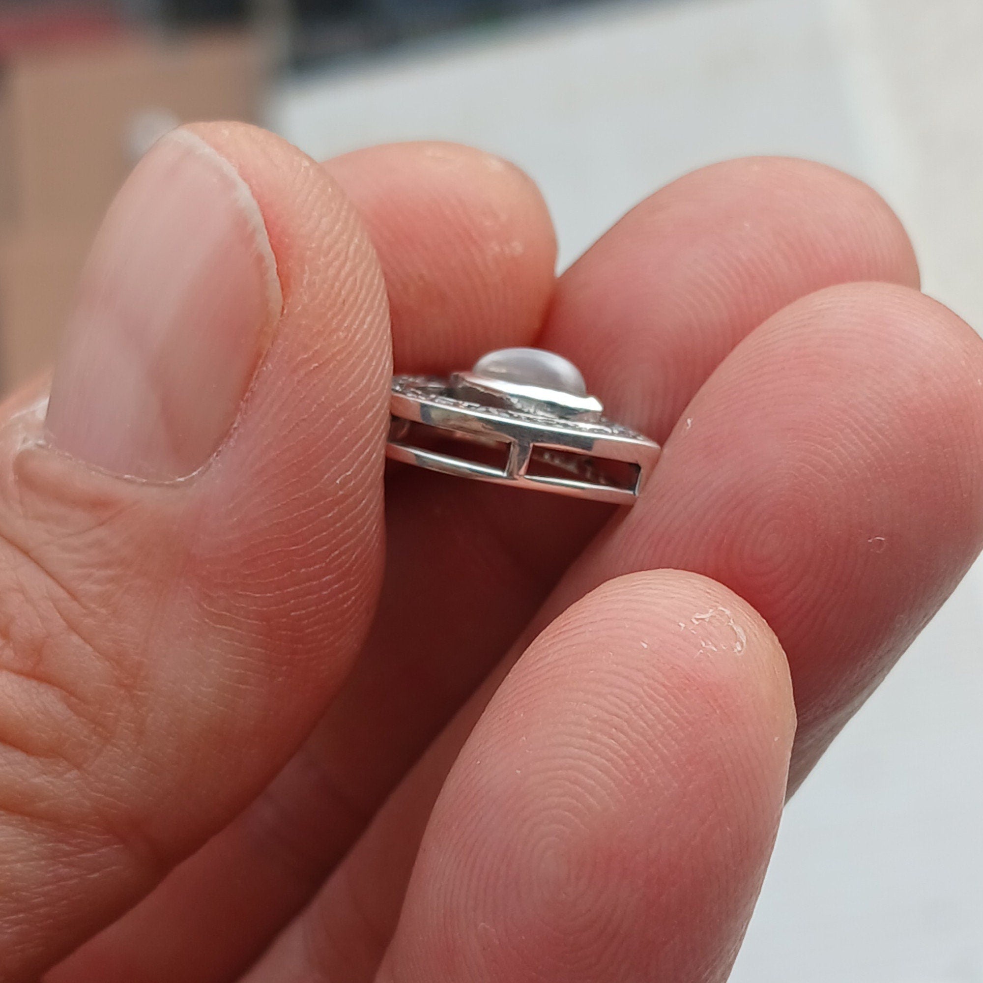 Sterling silver heart pendant featuring a Ceylon moonstone, elegantly designed with a shimmering finish.