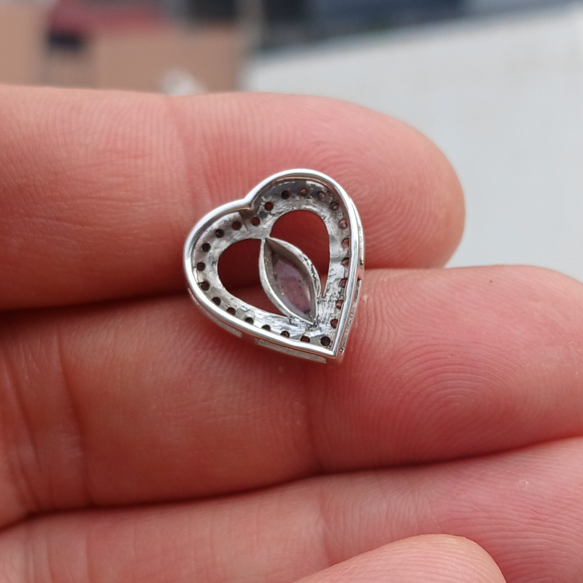 Sterling silver heart pendant featuring a Ceylon moonstone, elegantly designed with a shimmering finish.