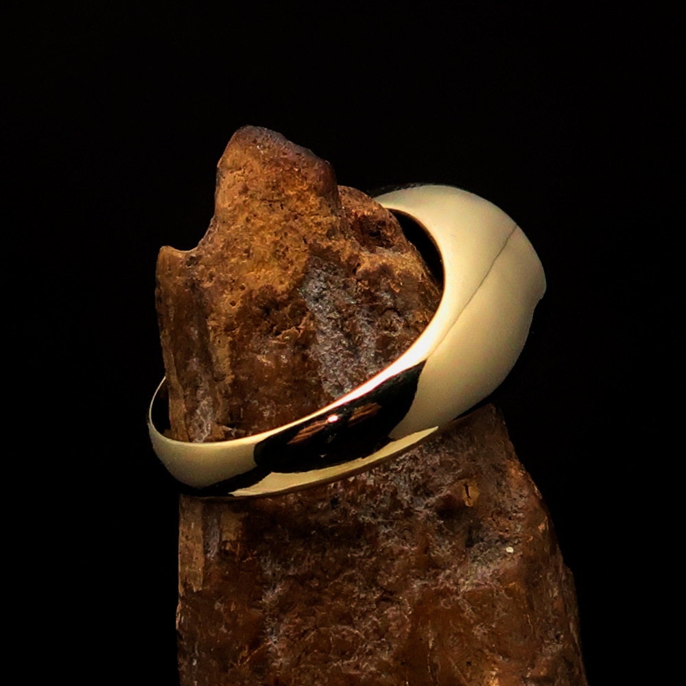 A polished brass oval-shaped pinky ring featuring the Hebrew word for Jesus, elegantly engraved and hallmarked 925.