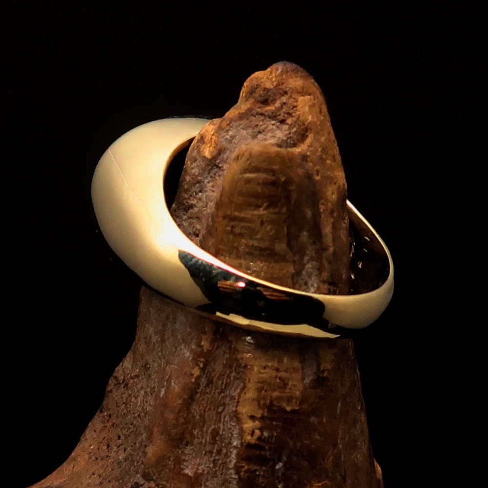 A polished brass oval-shaped pinky ring featuring the Hebrew word for Jesus, elegantly engraved and hallmarked 925.