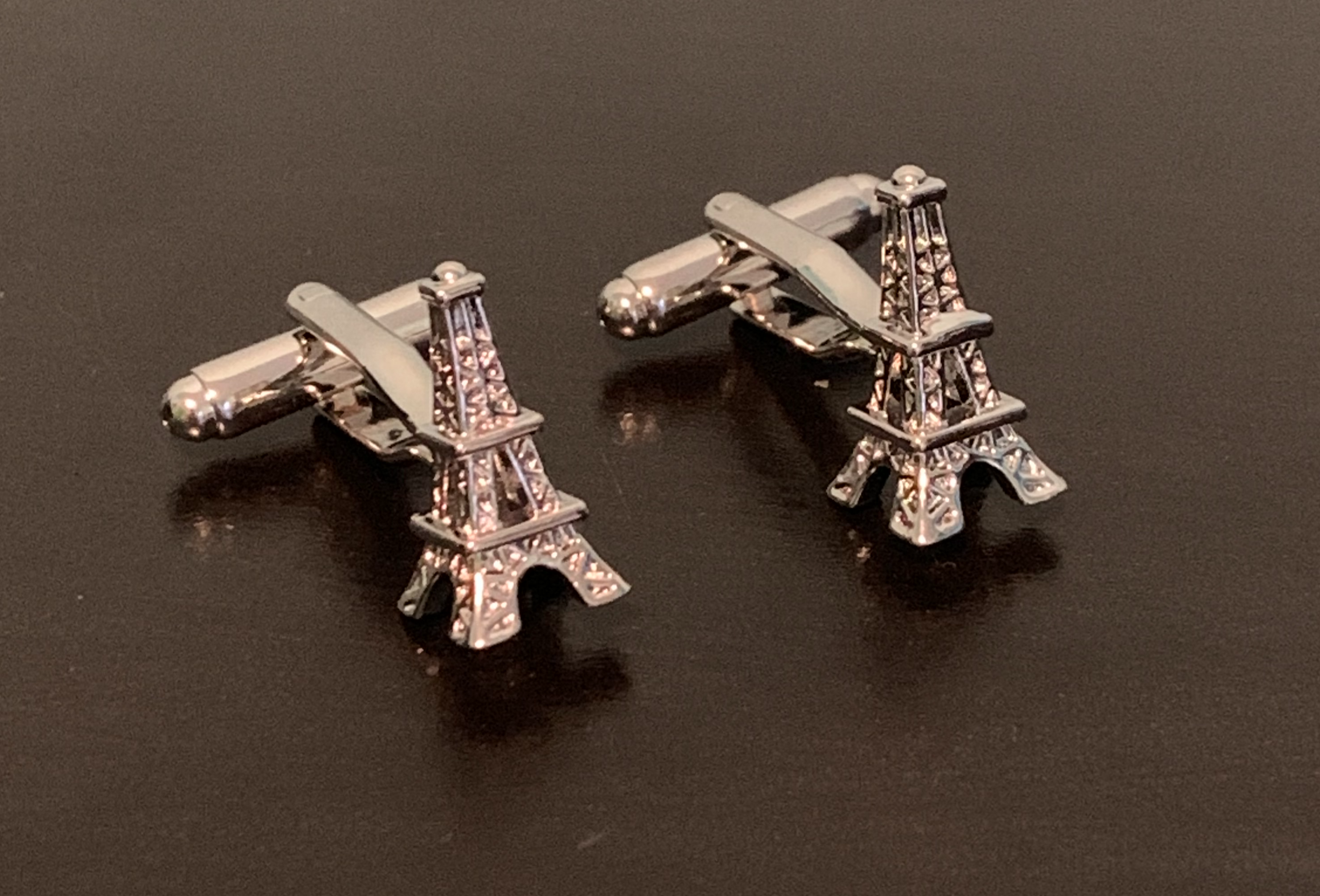 Elegant cufflinks featuring the Eiffel Tower design, symbolizing Parisian charm.