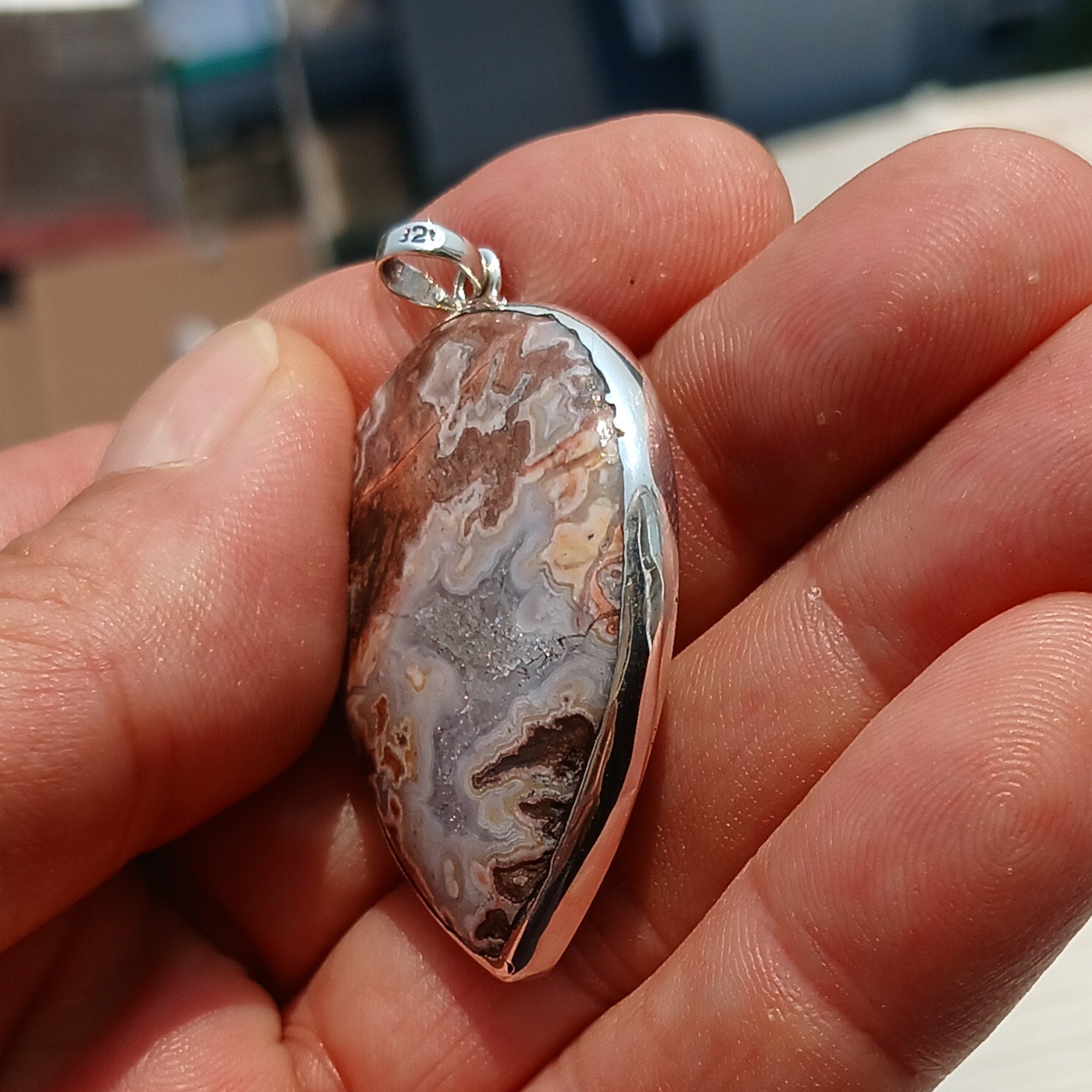A stunning pear-shaped Jasper pendant made of high-quality sterling silver, showcasing its elegant design and vibrant gemstone.