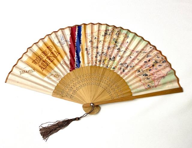 Journey to Armenia Hand Fan with bamboo ribs and shimmery brown tassel, displayed elegantly.