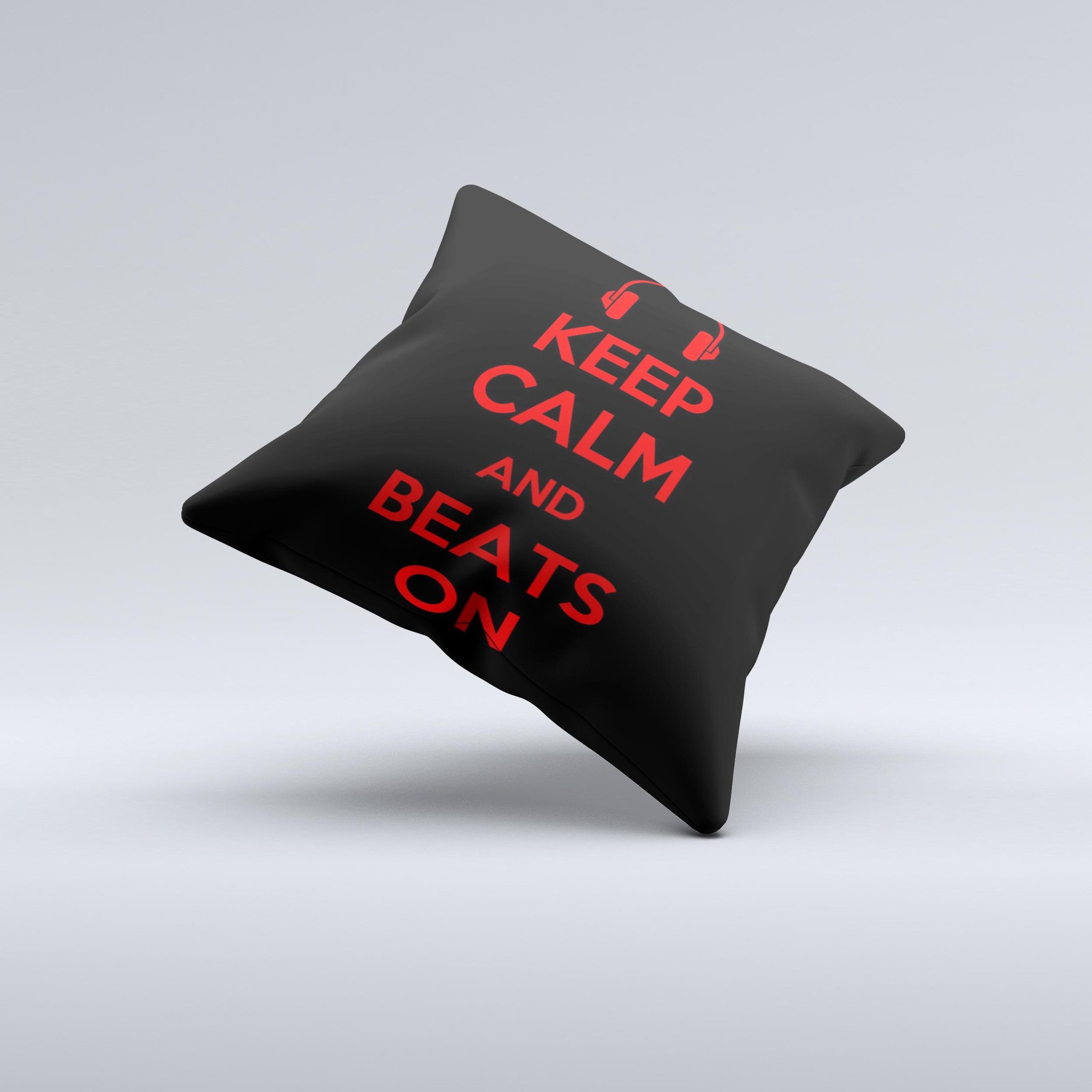 A vibrant red decorative throw pillow with the phrase 'Keep Calm & Beats On' in stylish ink-fuzed design, showcasing its handcrafted quality.