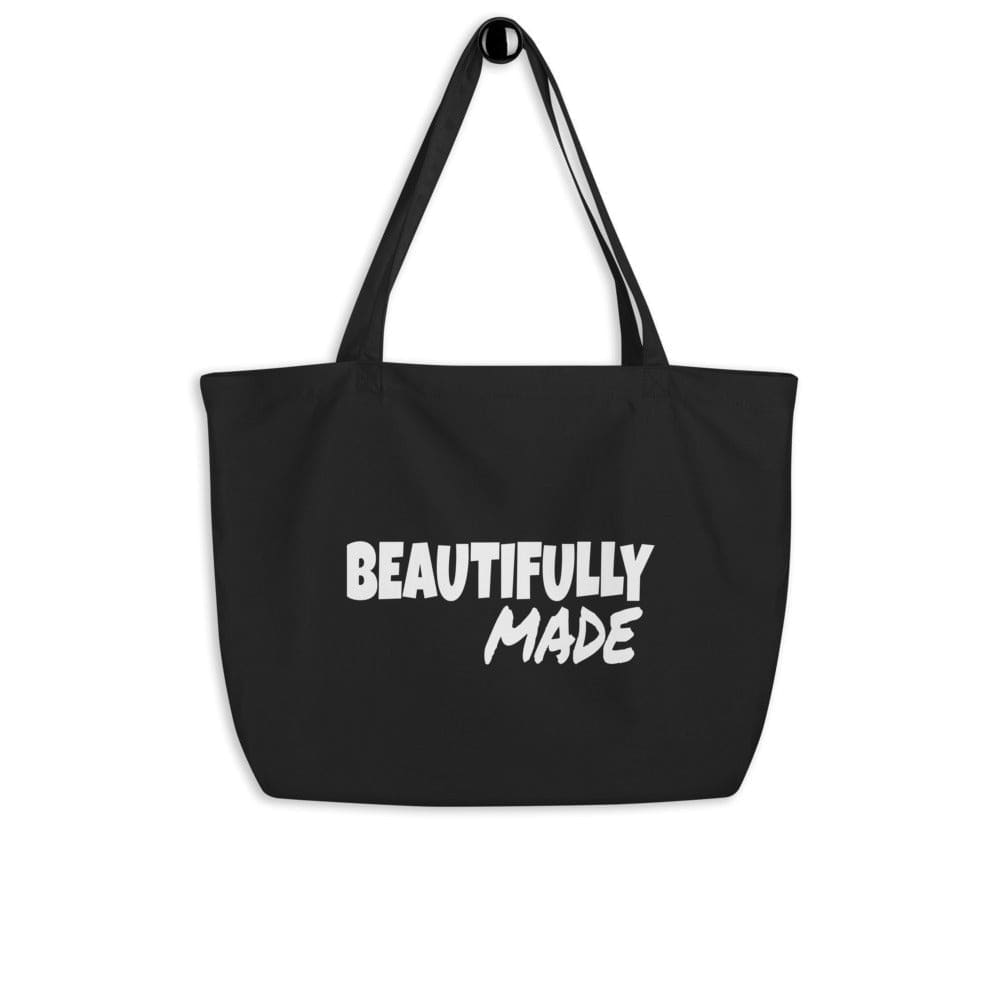 Large black tote bag made of durable cotton twill with inspirational print, featuring dual straps and spacious main compartment.