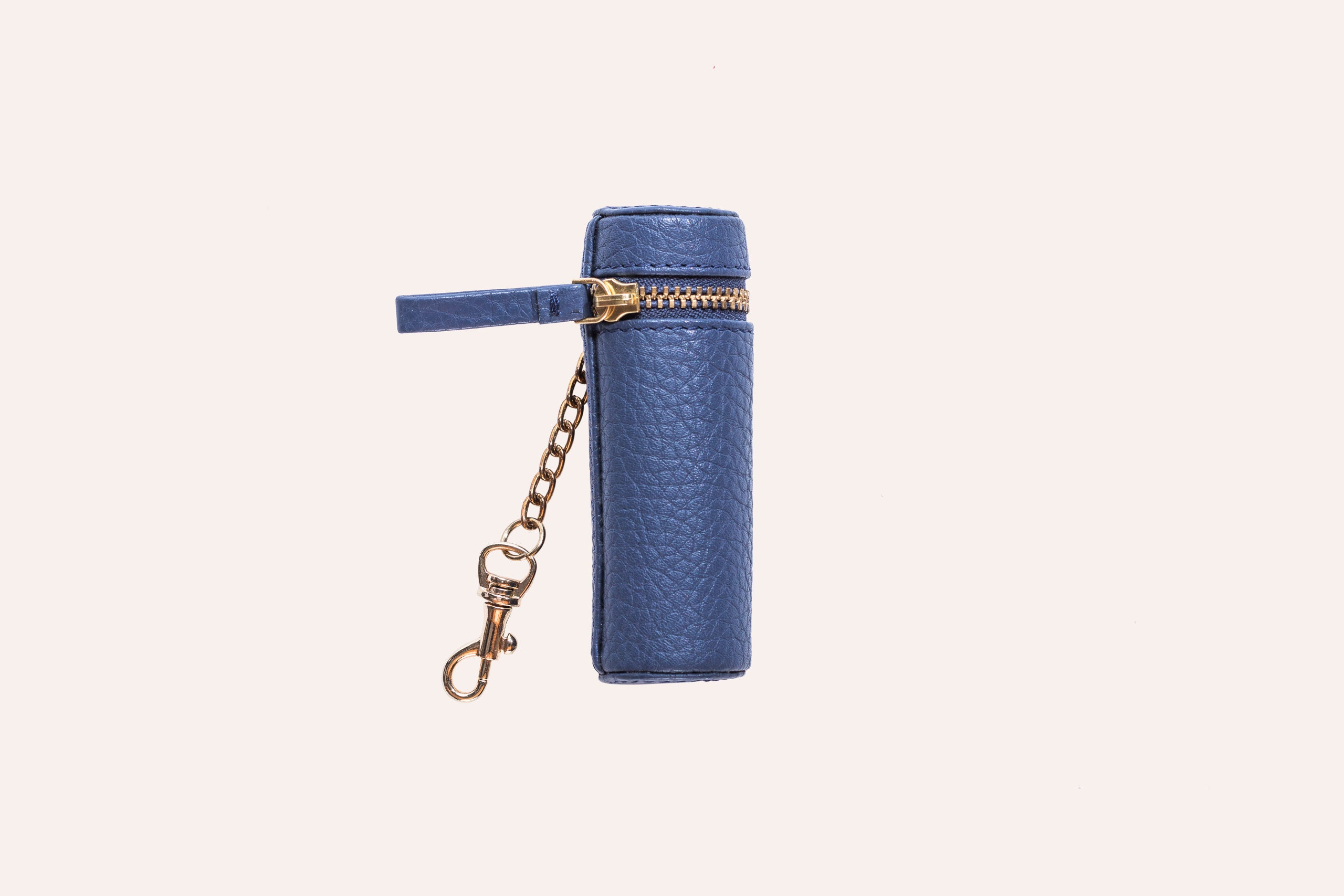 A stylish Lipstick Keeper made of genuine pebble leather, designed to hold lipsticks and chapsticks, featuring a compact size and attachment for bags.