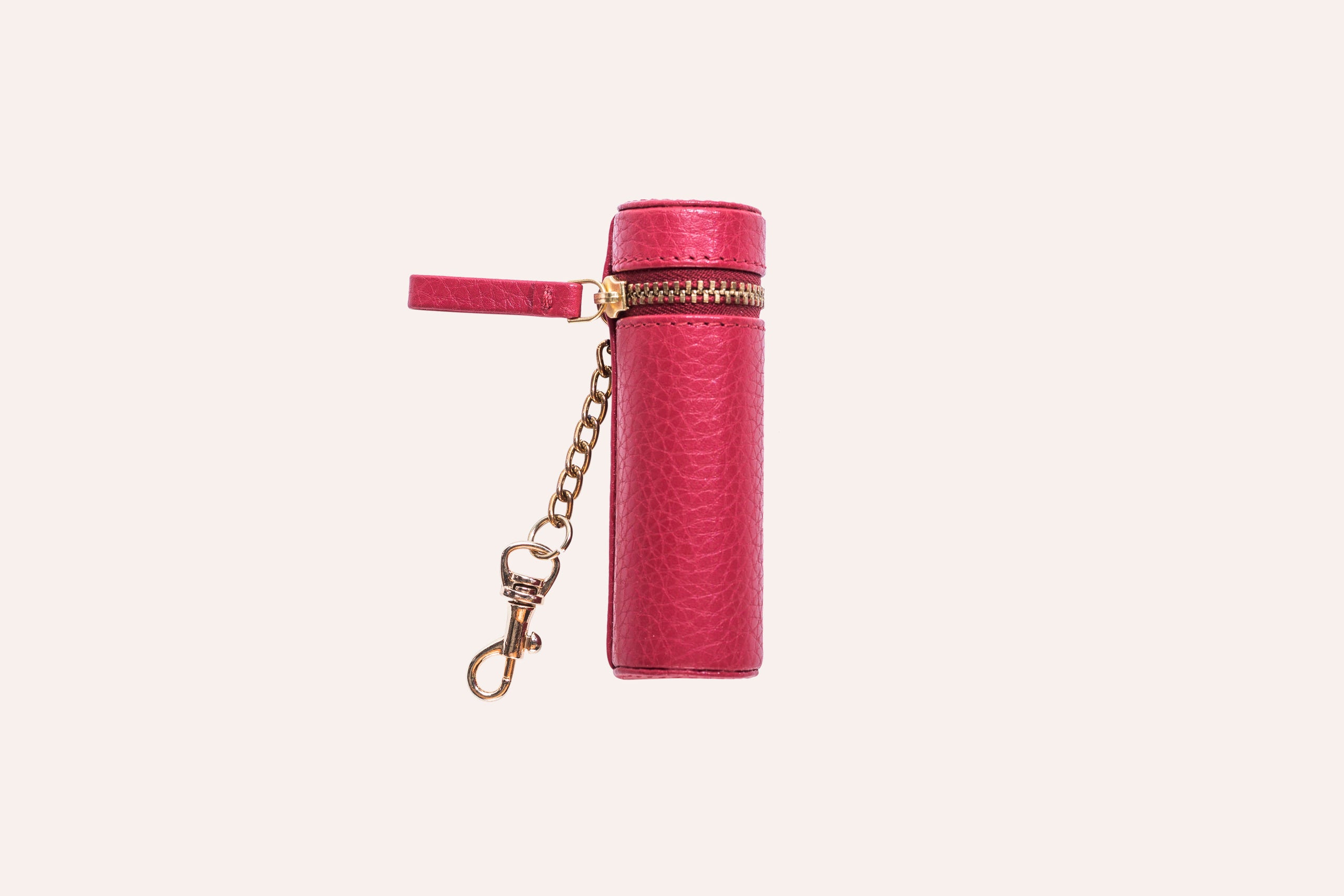 A stylish Lipstick Keeper made of genuine pebble leather, designed to hold lipsticks and chapsticks, featuring a compact size and attachment for bags.